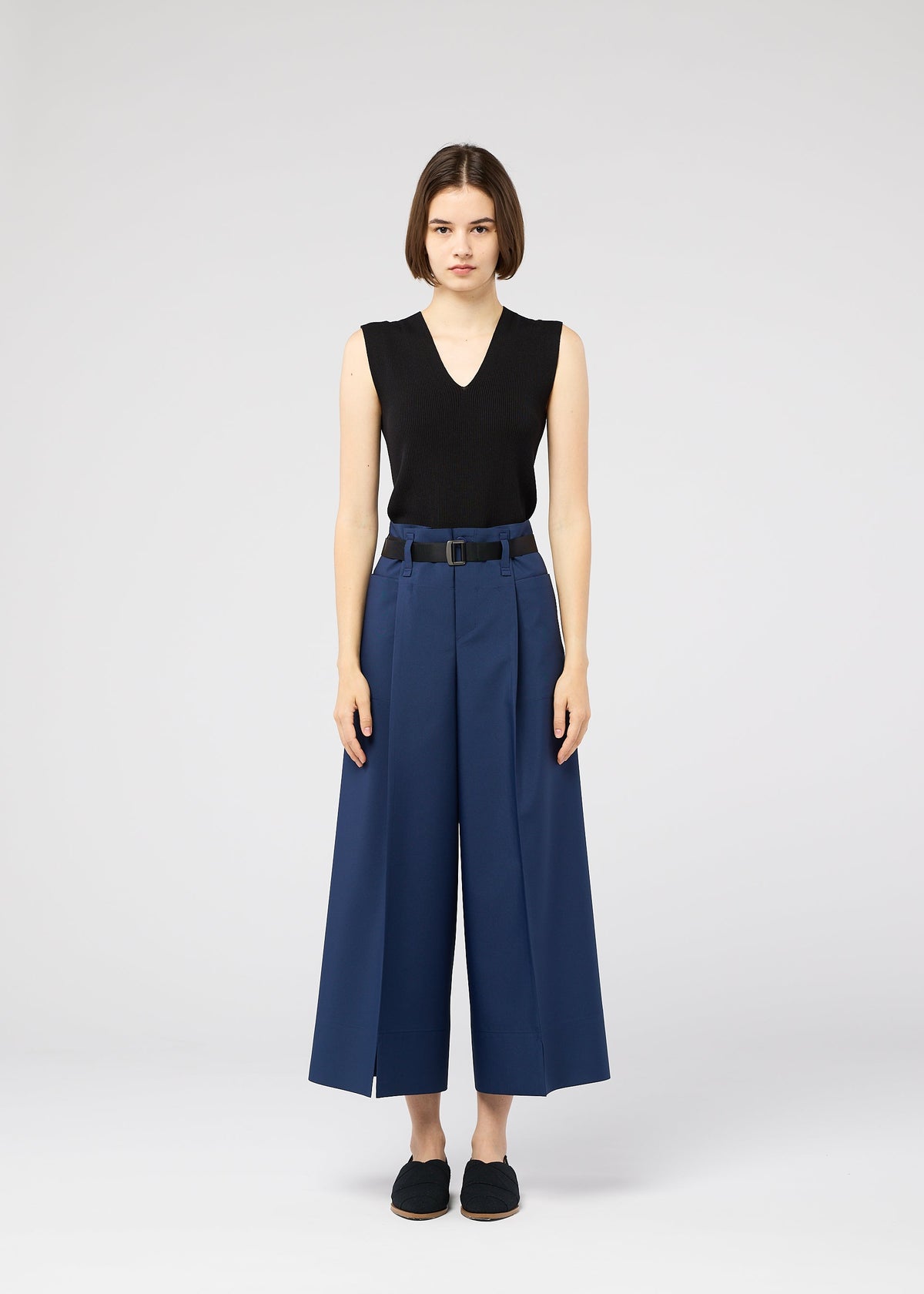 A model wears the 132 5. ISSEY MIYAKE 132 5. FLAT 2 trousers.