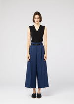 A model wears the 132 5. ISSEY MIYAKE 132 5. FLAT 2 trousers.