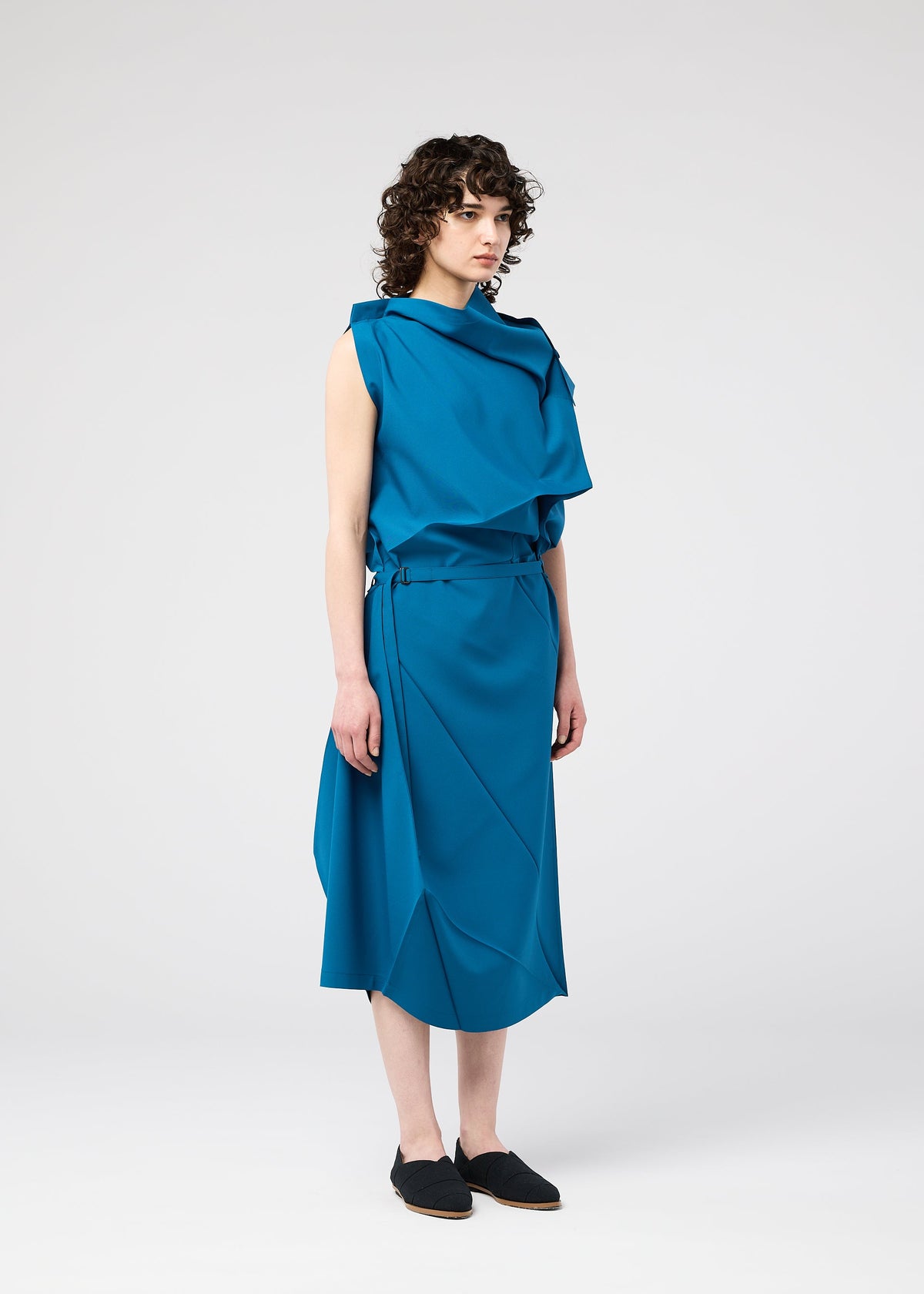 A model wears the 132 5. ISSEY MIYAKE FACET SOLID dress.