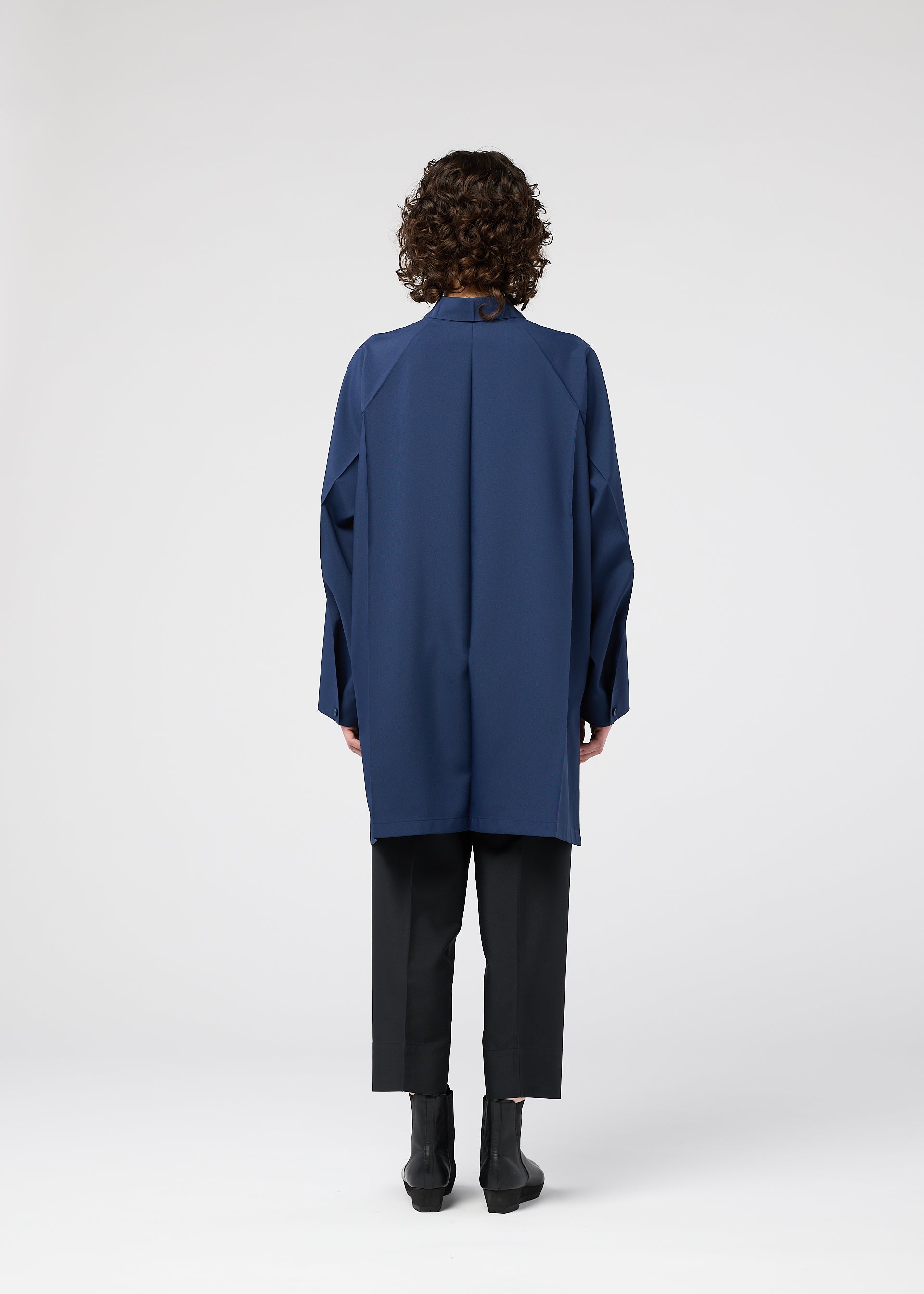 A model wears the 132 5. ISSEY MIYAKE FOLD SHIRT shirt.