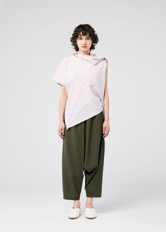 A model wears the 132 5. ISSEY MIYAKE RADIAL FOLD SHIRT top.