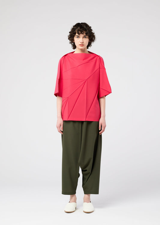 A model wears the 132 5. ISSEY MIYAKE RADIAL FOLD SHIRT top.