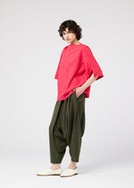 A model wears the 132 5. ISSEY MIYAKE RADIAL FOLD SHIRT top.