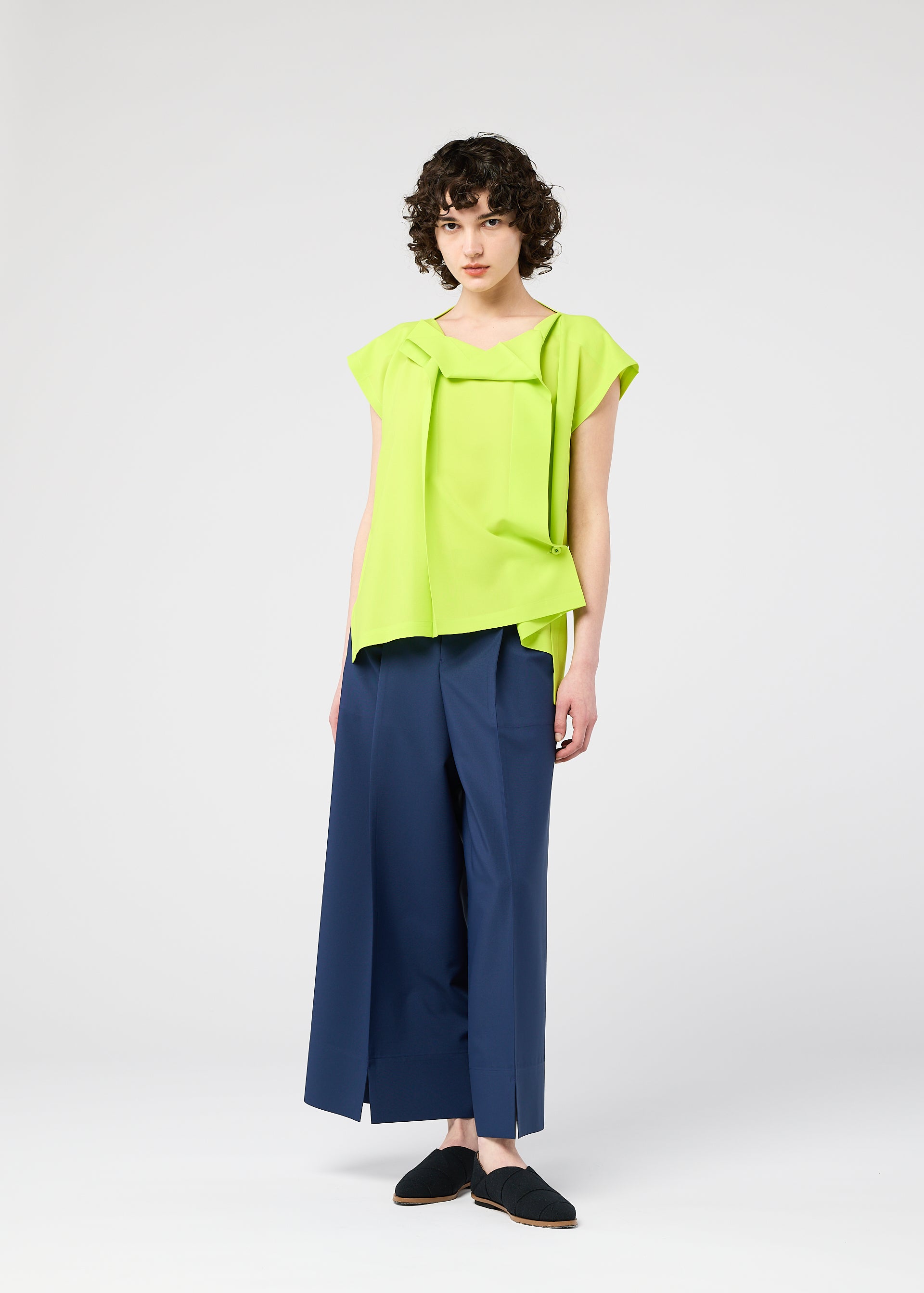 A model wears the 132 5. ISSEY MIYAKE FLAT TUCK T flat-tuck-t-shirt-white.
