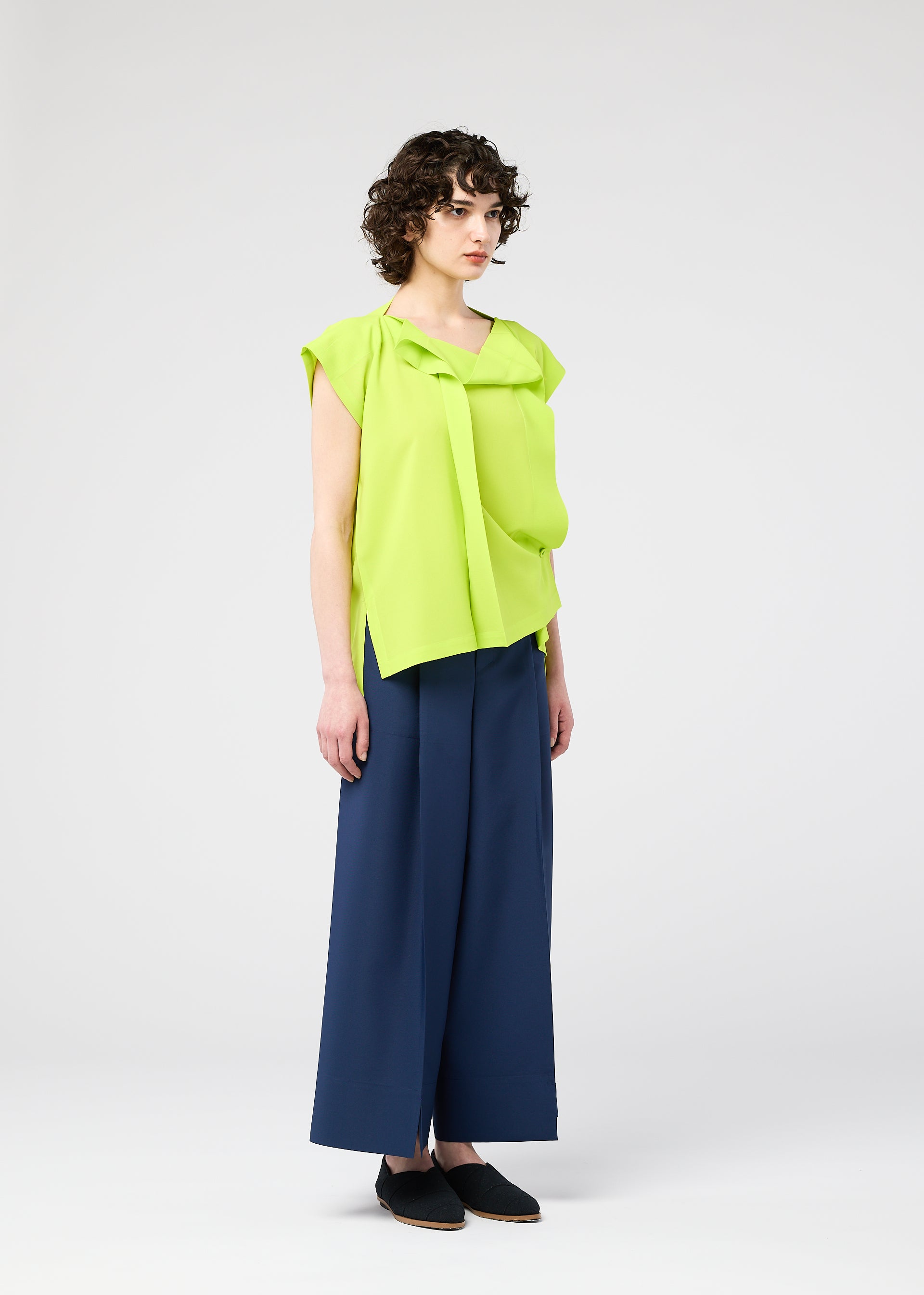 A model wears the 132 5. ISSEY MIYAKE FLAT TUCK T flat-tuck-t-shirt-white.