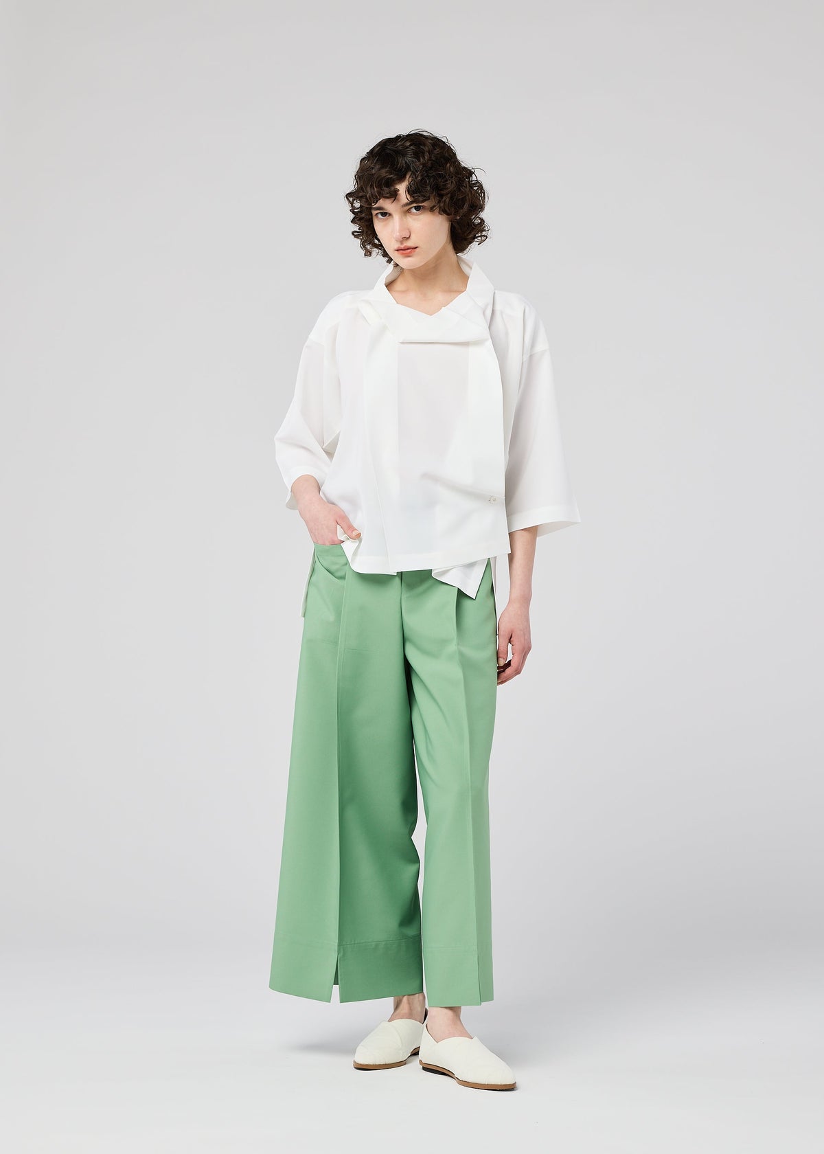 A model wears the 132 5. ISSEY MIYAKE FLAT TUCK T flat-tuck-t-shirt-black-1.