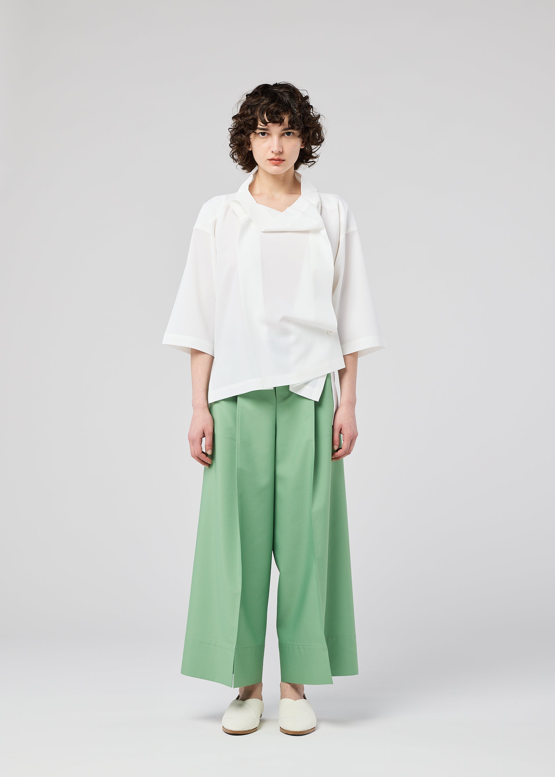 A model wears the 132 5. ISSEY MIYAKE FLAT TUCK T flat-tuck-t-shirt-yellow-green-1.