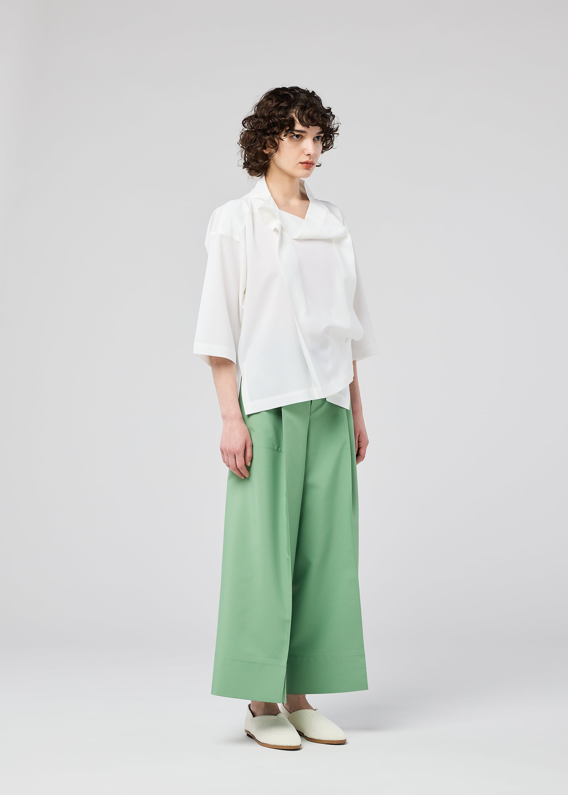 A model wears the 132 5. ISSEY MIYAKE FLAT TUCK T flat-tuck-t-shirt-white-1.
