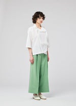 A model wears the 132 5. ISSEY MIYAKE FLAT TUCK T flat-tuck-t-shirt-yellow-green-1.