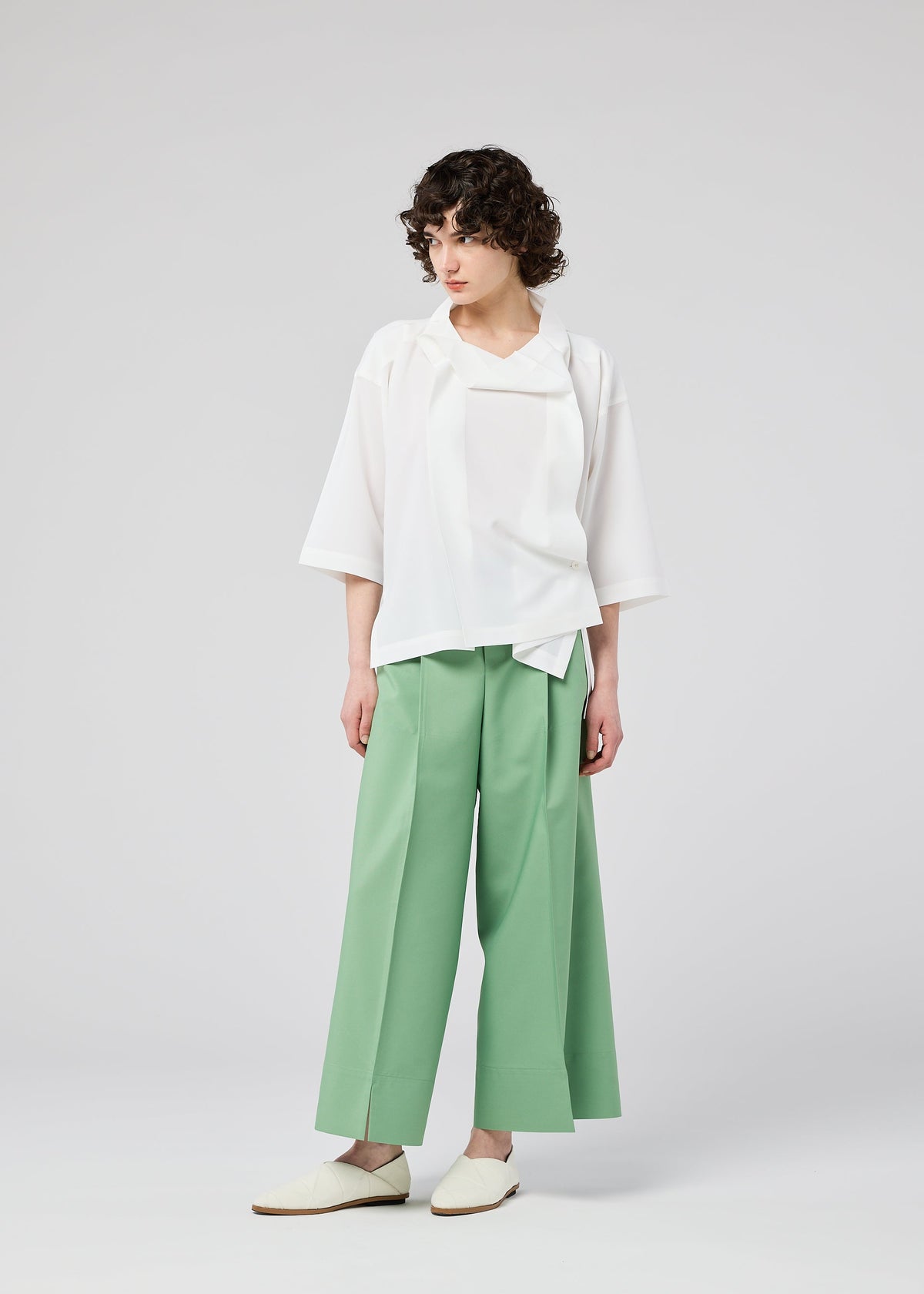A model wears the 132 5. ISSEY MIYAKE FLAT TUCK T flat-tuck-t-shirt-white-1.