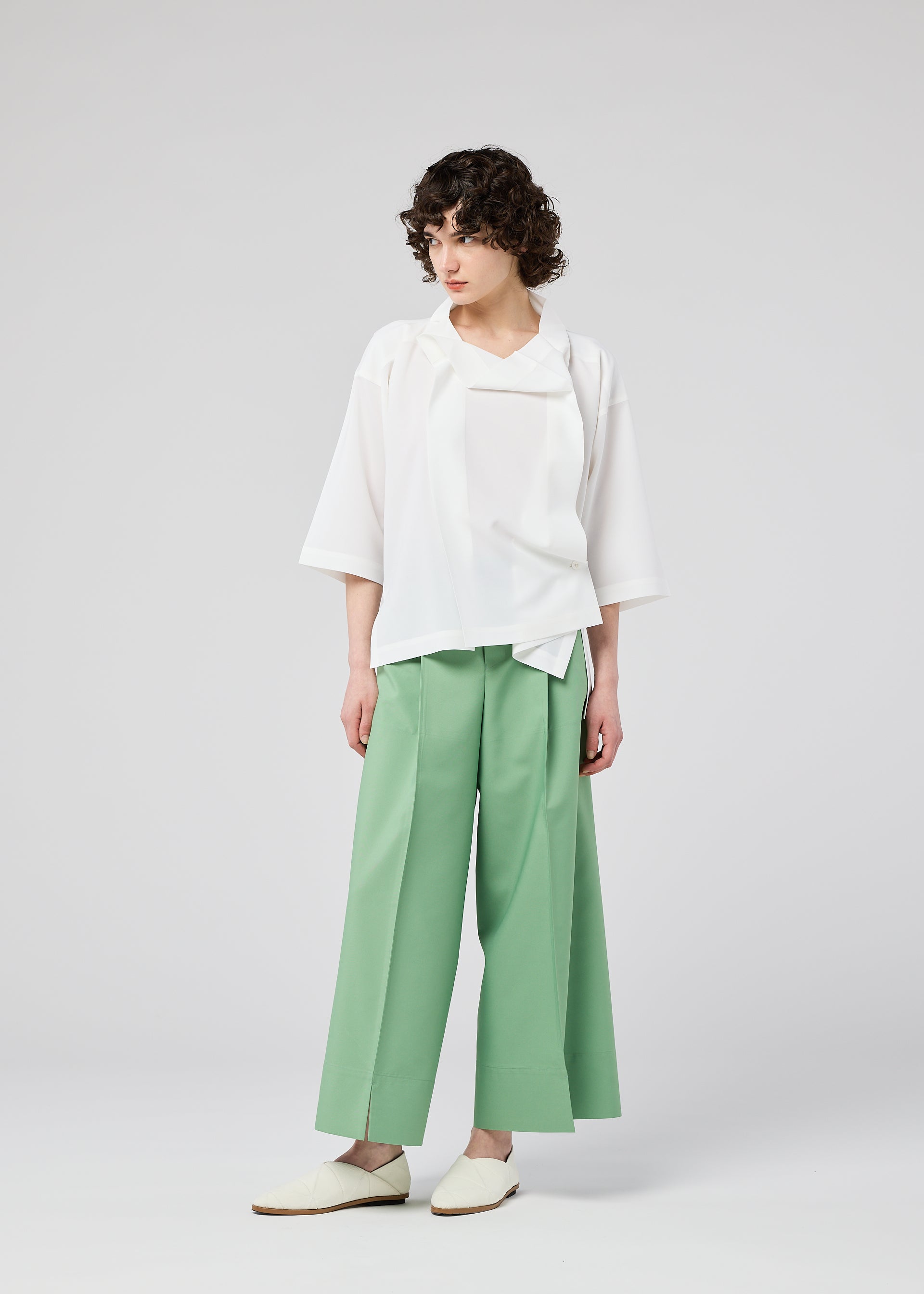 A model wears the 132 5. ISSEY MIYAKE FLAT TUCK T flat-tuck-t-shirt-yellow-green-1.