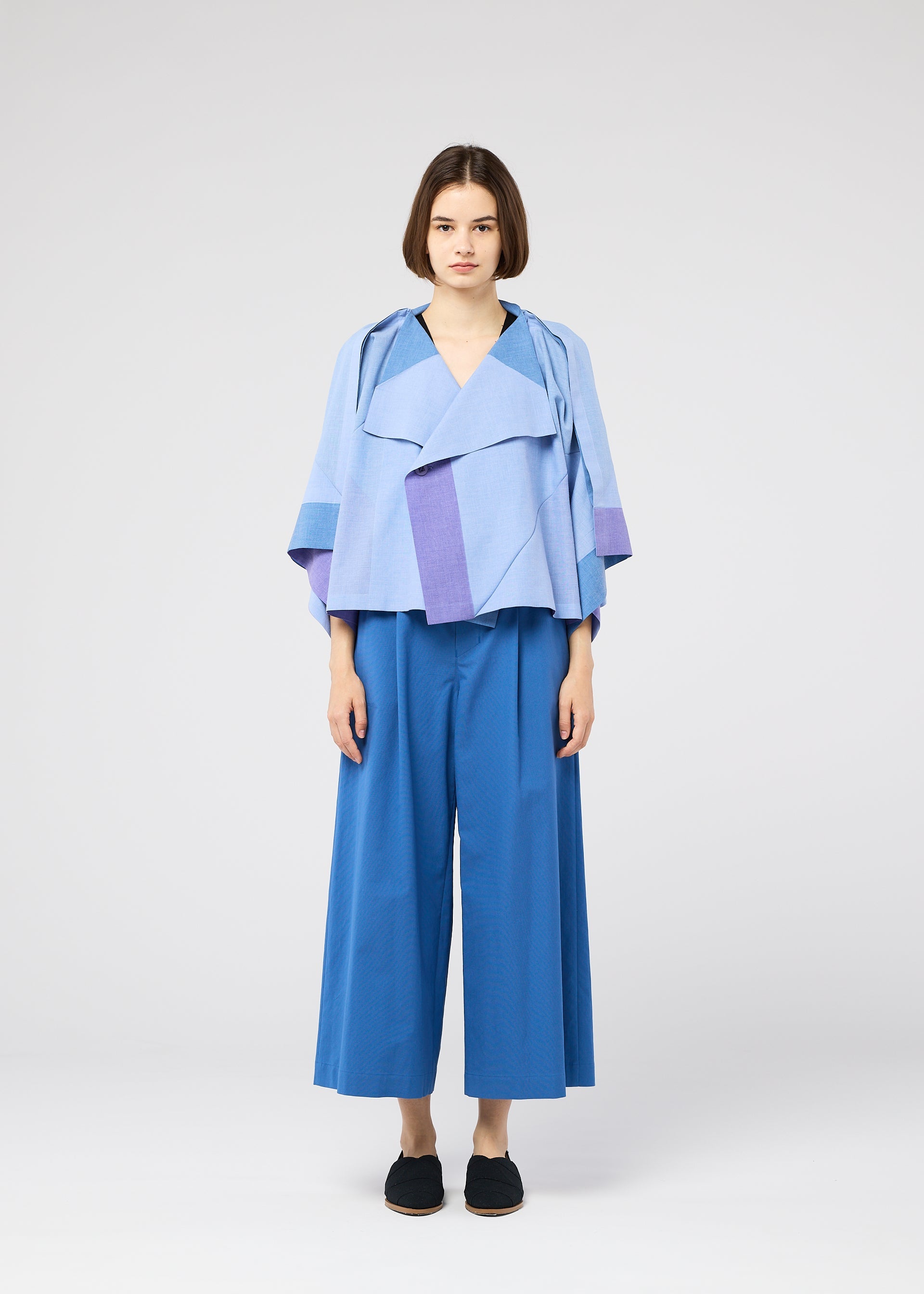 A model wears the 132 5. ISSEY MIYAKE FOLD RAMIE PRINT shirt.