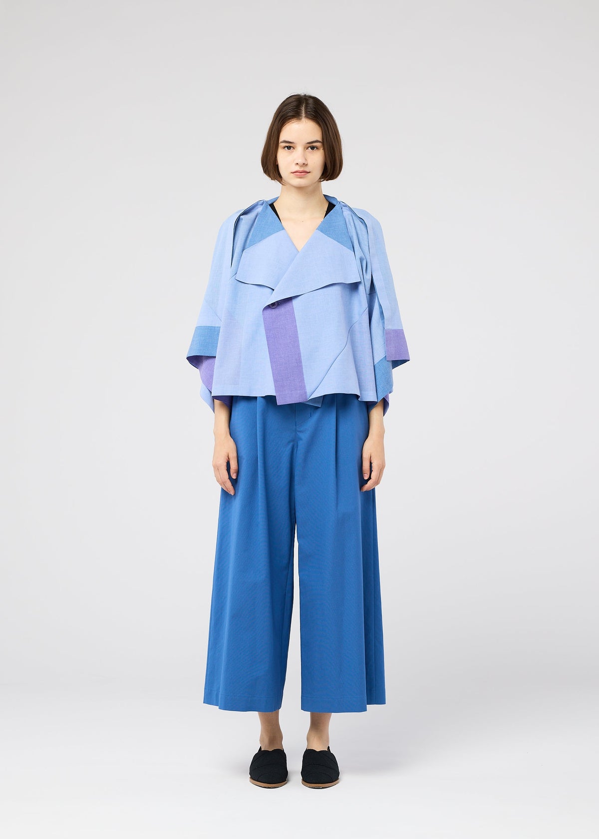 A model wears the 132 5. ISSEY MIYAKE FOLD RAMIE PRINT shirt.