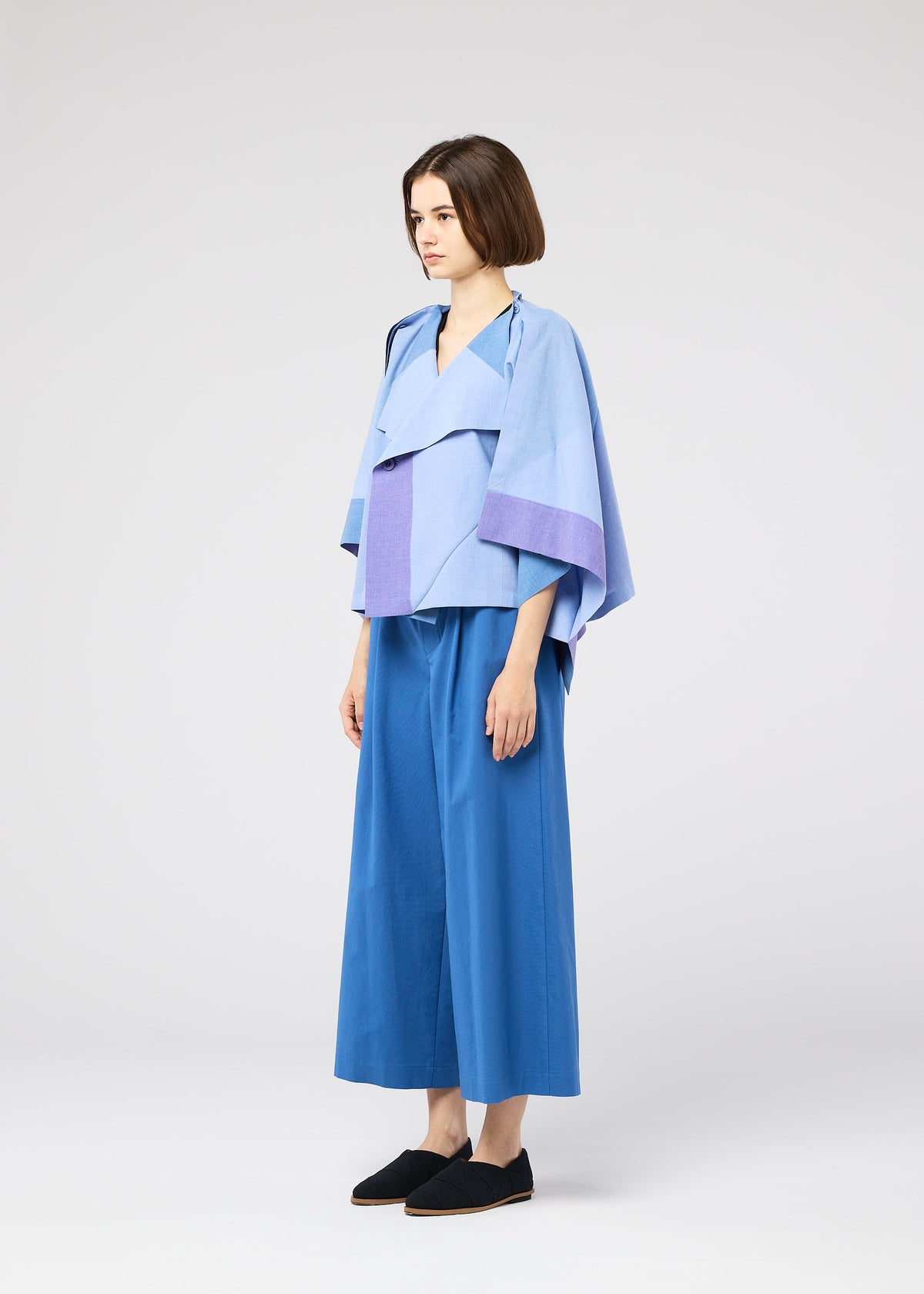 A model wears the 132 5. ISSEY MIYAKE FOLD RAMIE PRINT shirt.