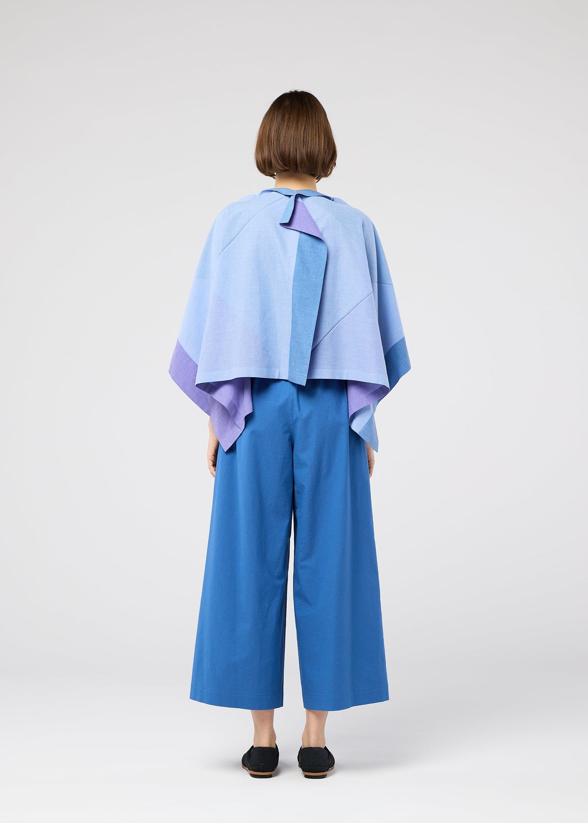 A model wears the 132 5. ISSEY MIYAKE FOLD RAMIE PRINT shirt.