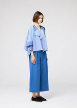 A model wears the 132 5. ISSEY MIYAKE FOLD RAMIE PRINT shirt.