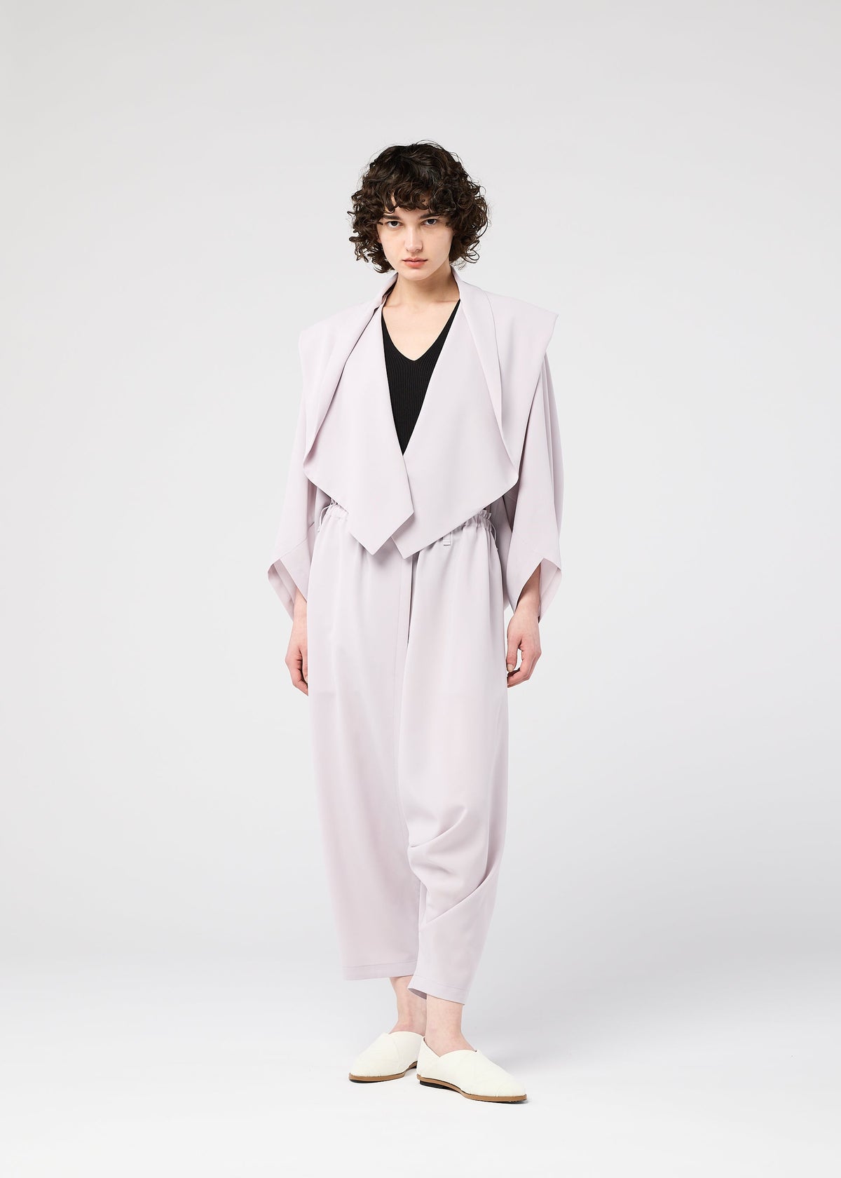 A model wears the 132 5. ISSEY MIYAKE SEAMLESS cardigan.