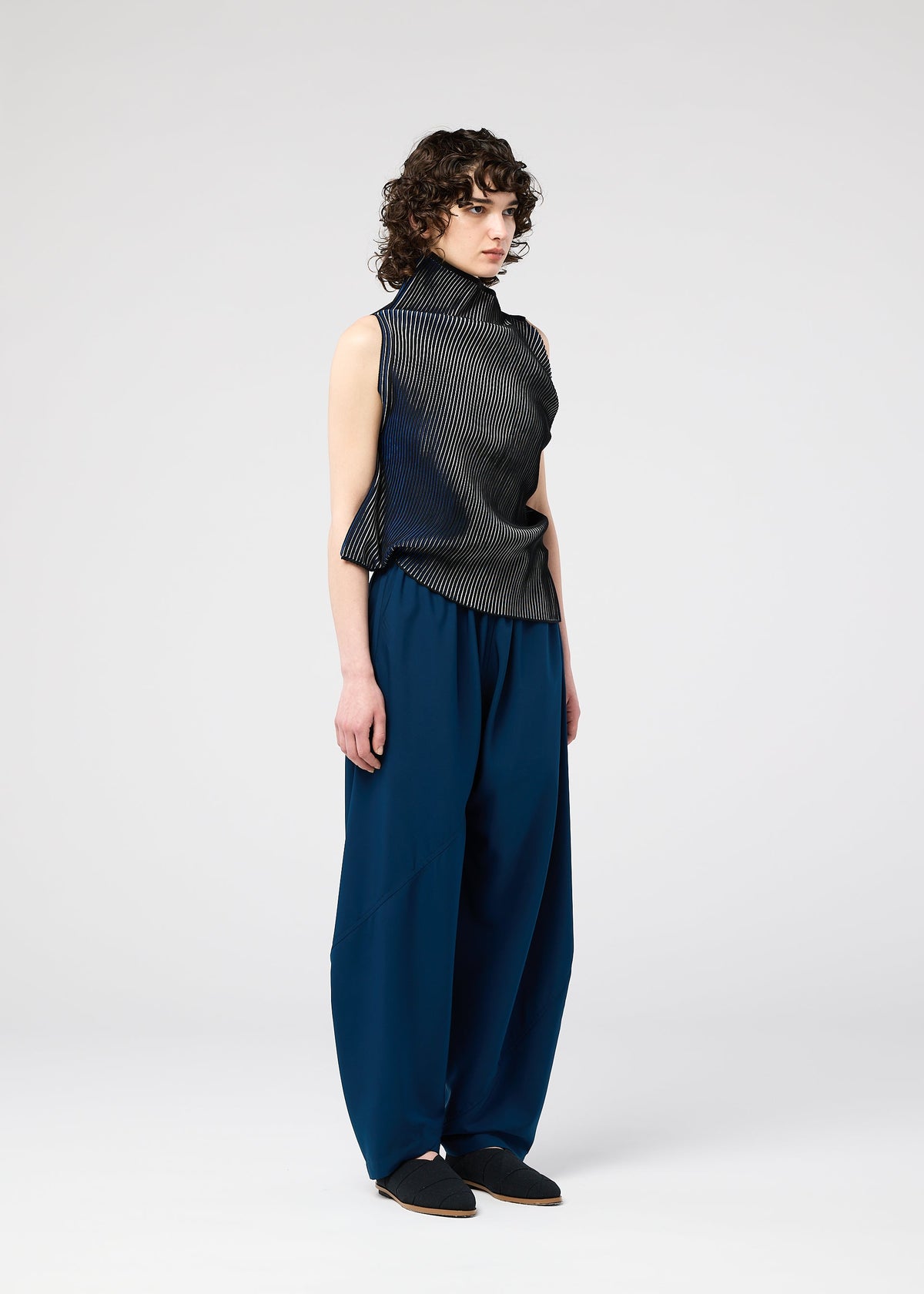 A model wears the 132 5. ISSEY MIYAKE FACET KNIT top.