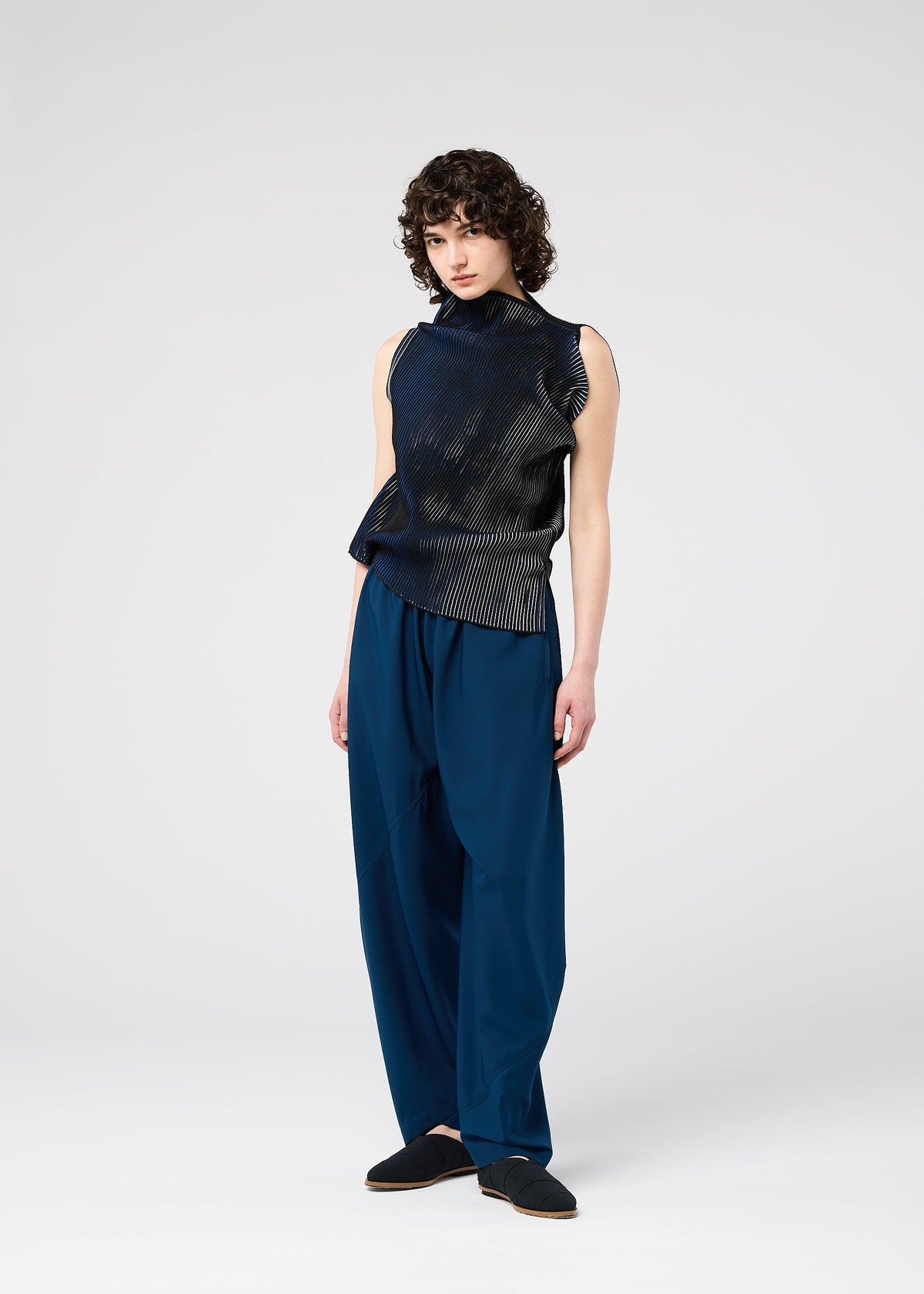 A model wears the 132 5. ISSEY MIYAKE FACET KNIT top.