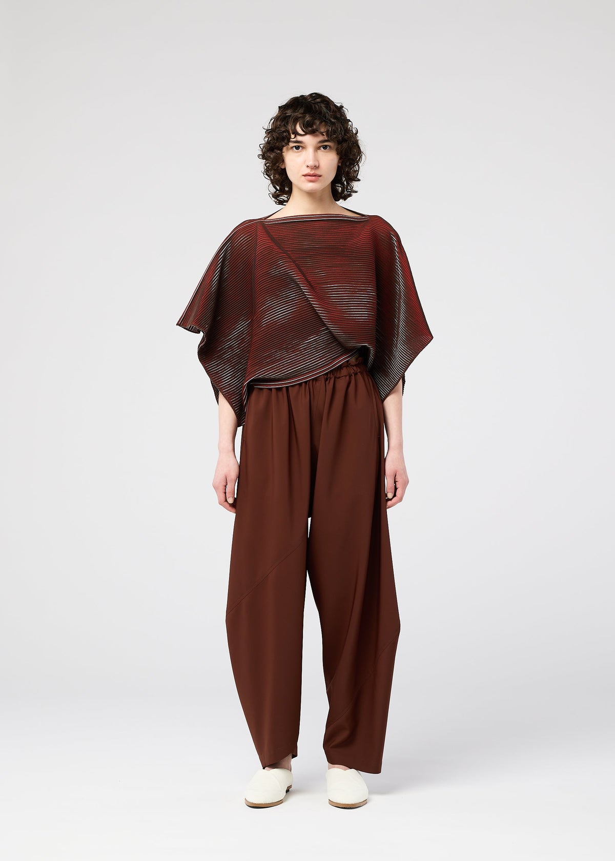 A model wears the 132 5. ISSEY MIYAKE FACET KNIT top.