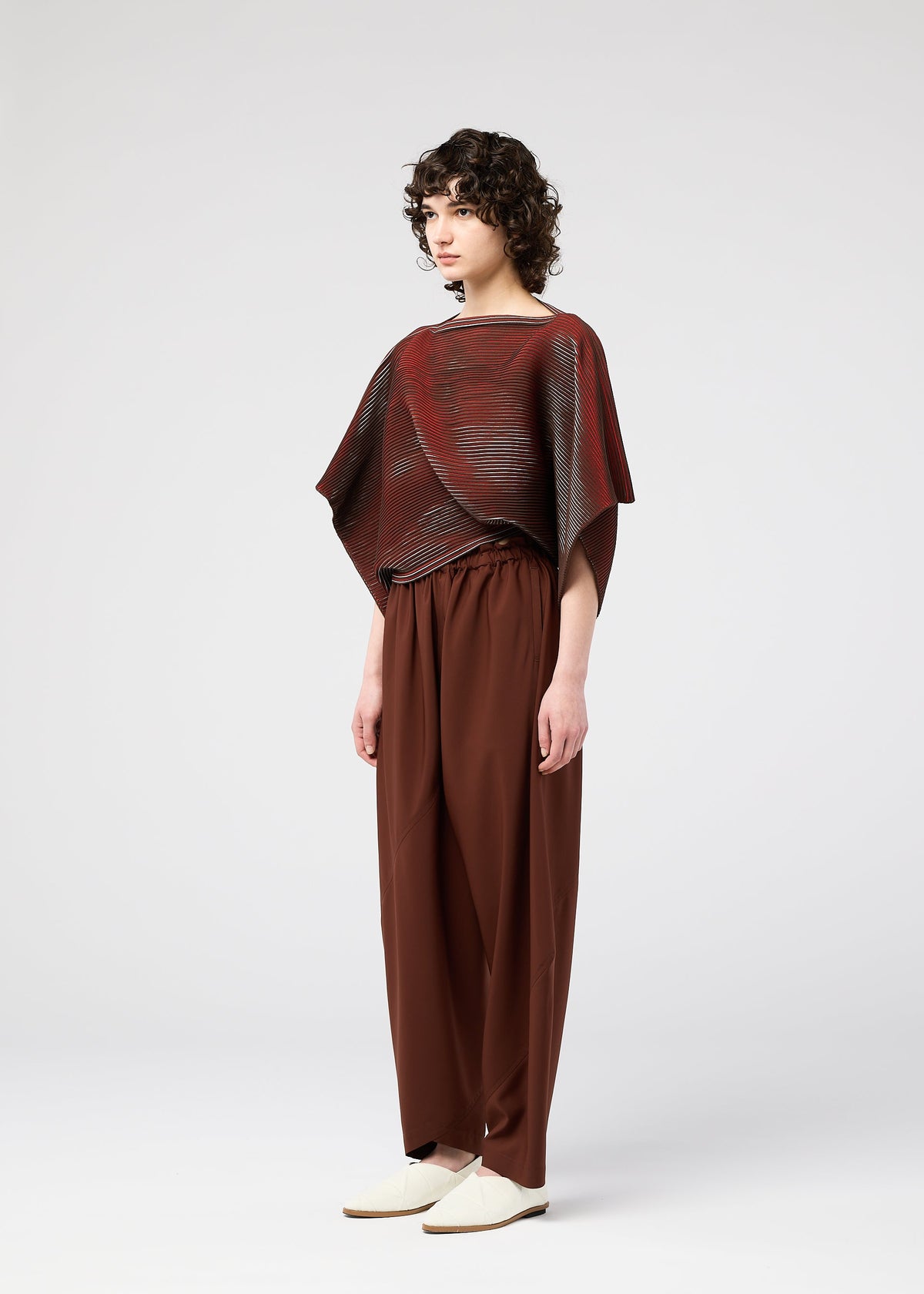 A model wears the 132 5. ISSEY MIYAKE FACET KNIT top.