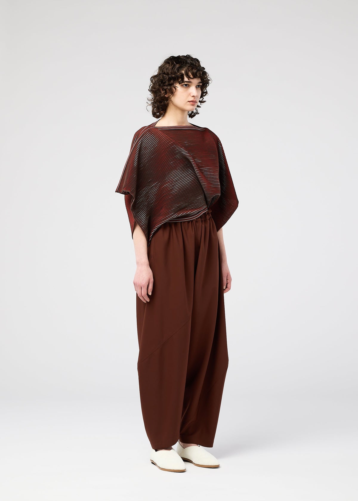 A model wears the 132 5. ISSEY MIYAKE FACET KNIT top.