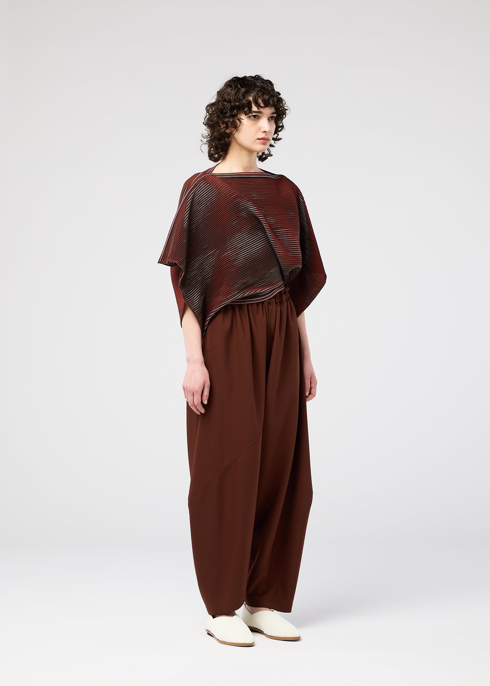 A model wears the 132 5. ISSEY MIYAKE FACET KNIT top.