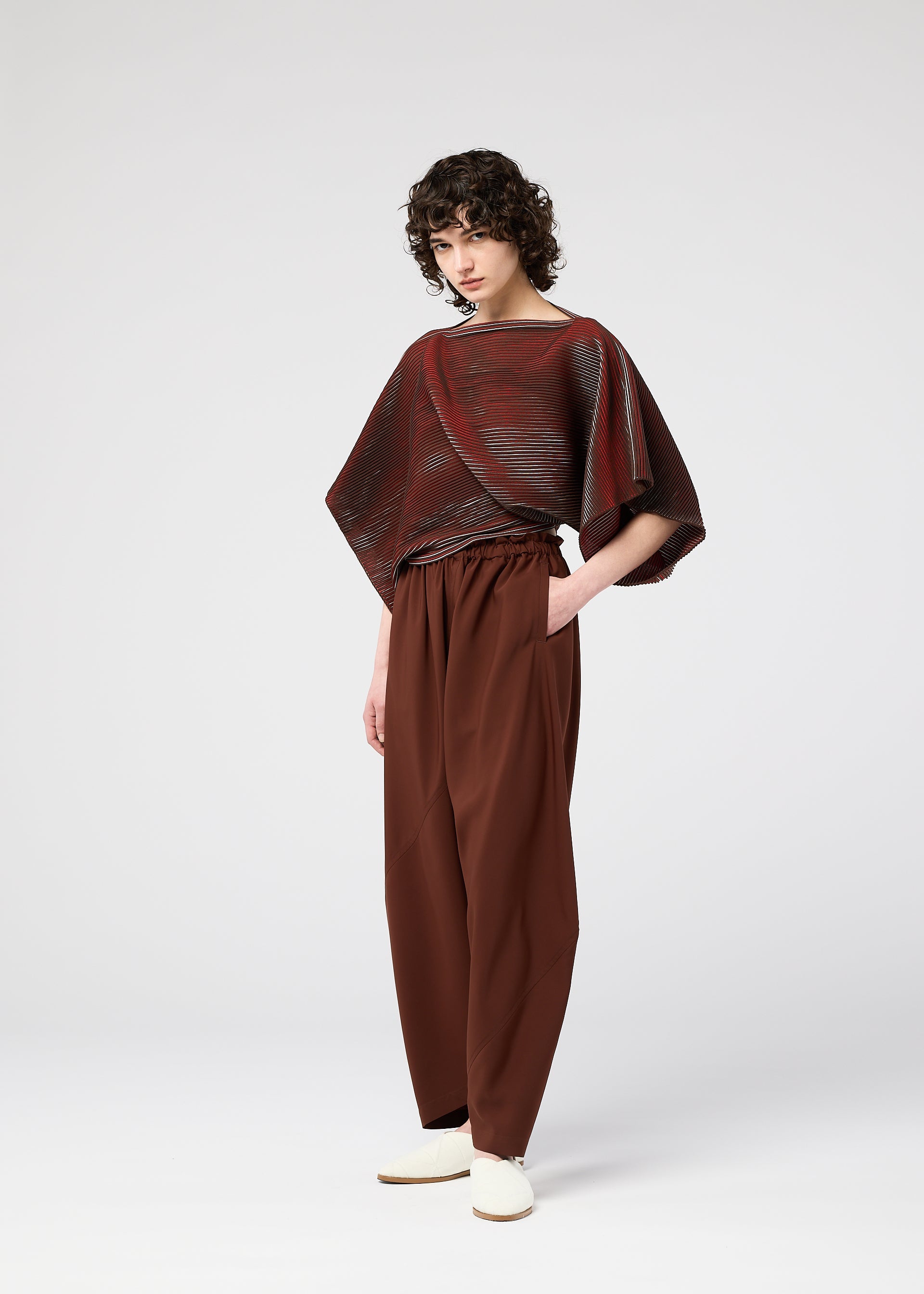 A model wears the 132 5. ISSEY MIYAKE FACET KNIT top.