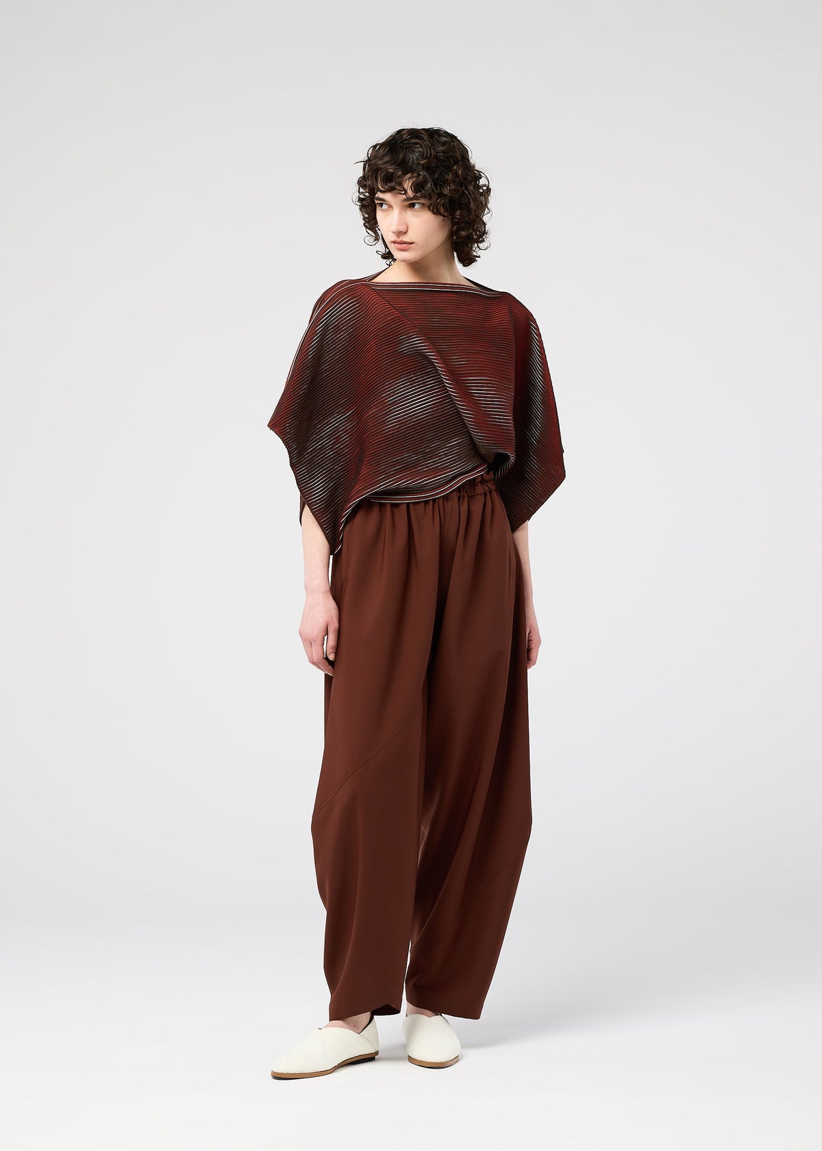 A model wears the 132 5. ISSEY MIYAKE FACET KNIT top.