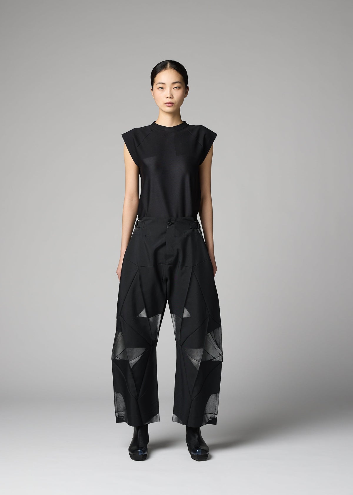 A model wears the 132 5. ISSEY MIYAKE F-BT f-bt-trousers-black-x-silver.