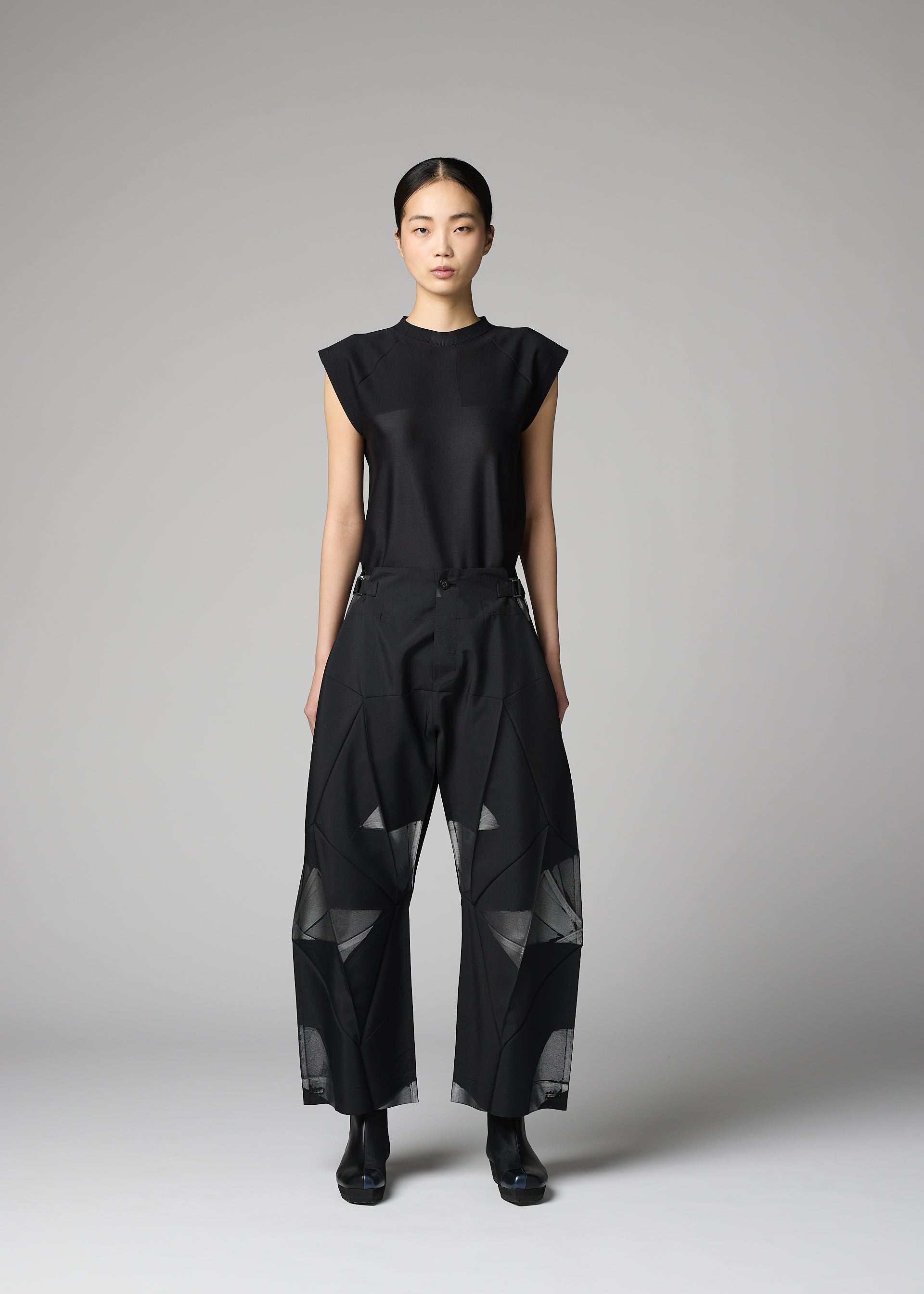 A model wears the 132 5. ISSEY MIYAKE F-BT f-bt-trousers-black-x-silver.