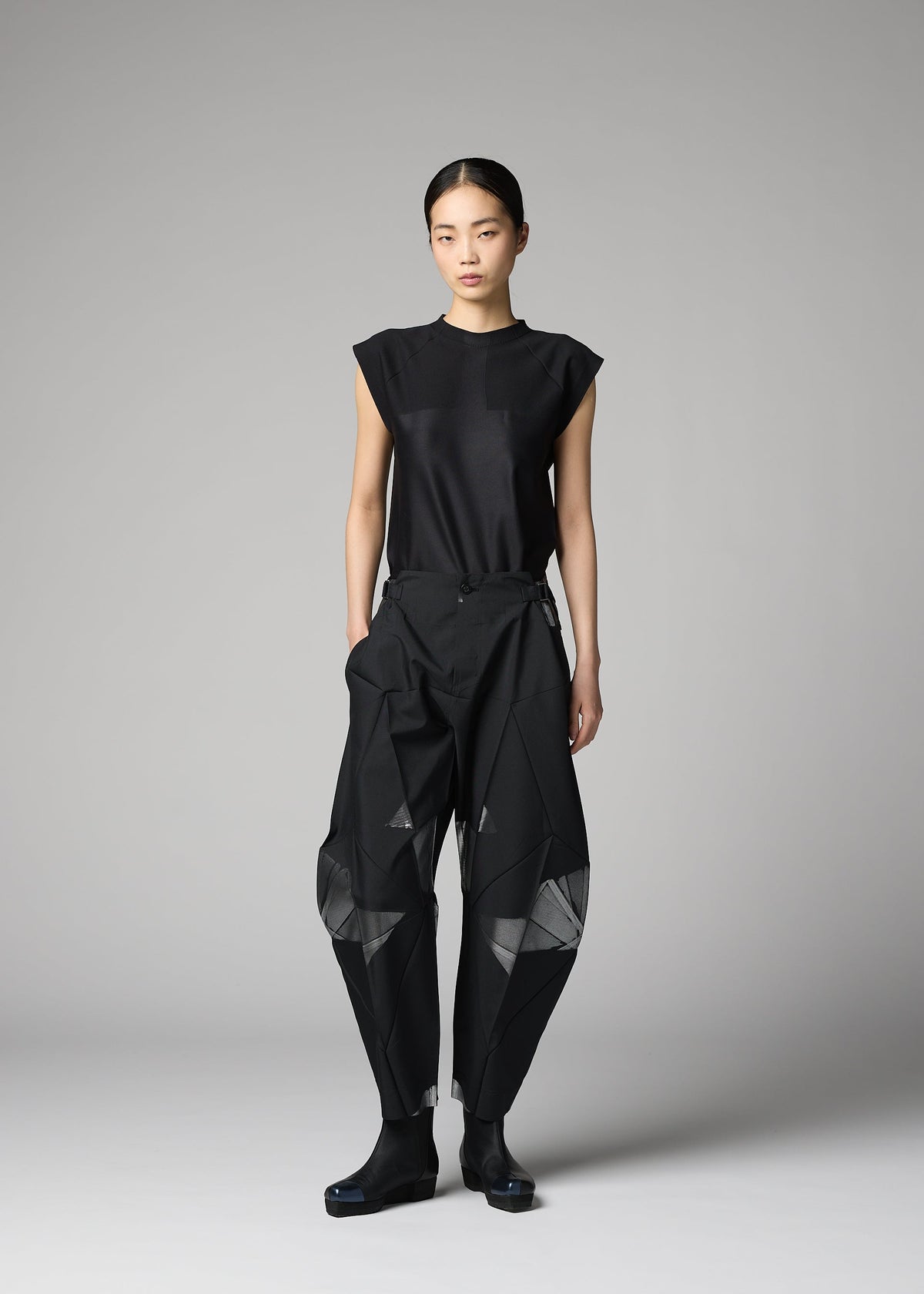 A model wears the 132 5. ISSEY MIYAKE F-BT f-bt-trousers-black-x-silver.