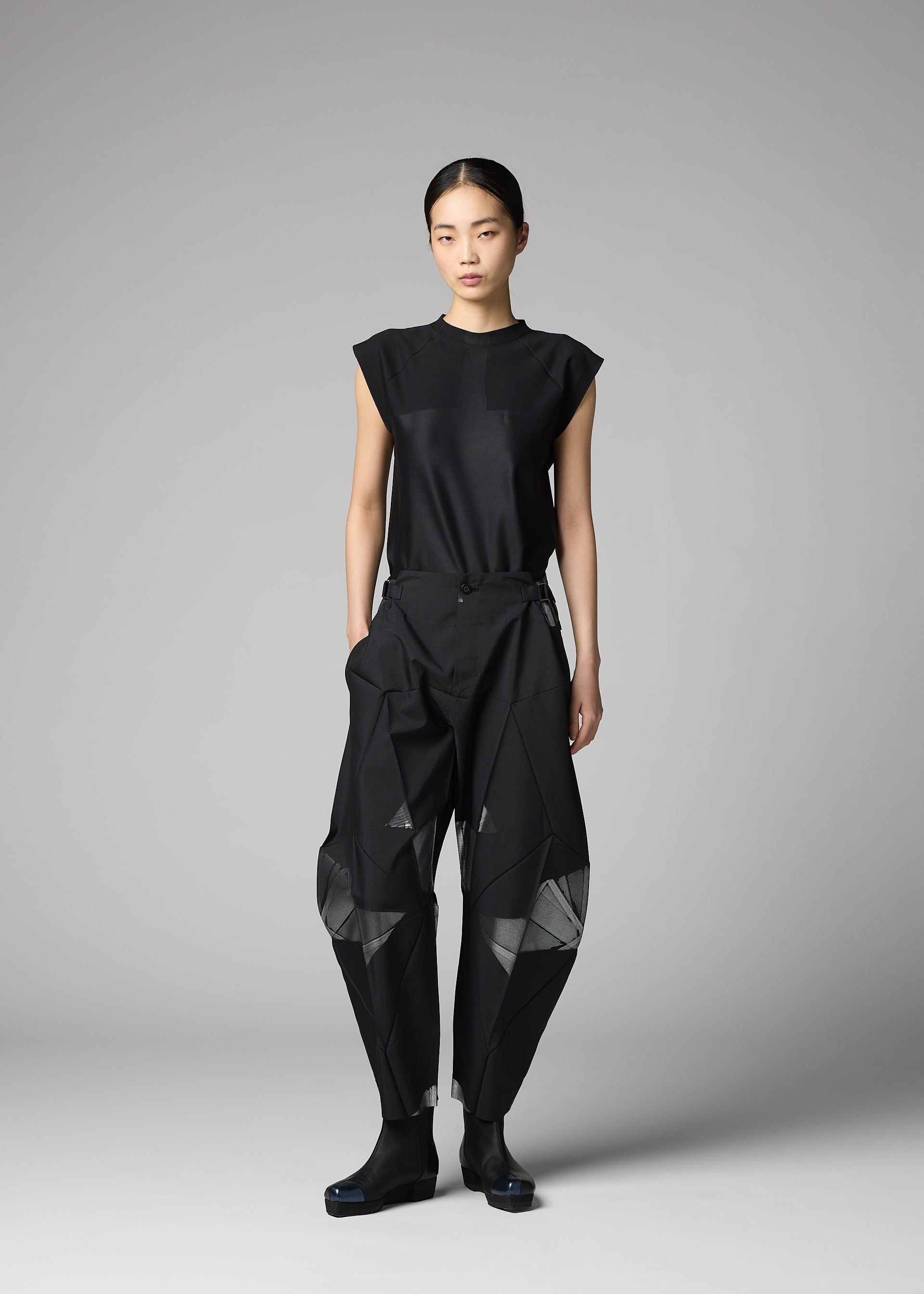 A model wears the 132 5. ISSEY MIYAKE F-BT f-bt-trousers-black-x-silver.