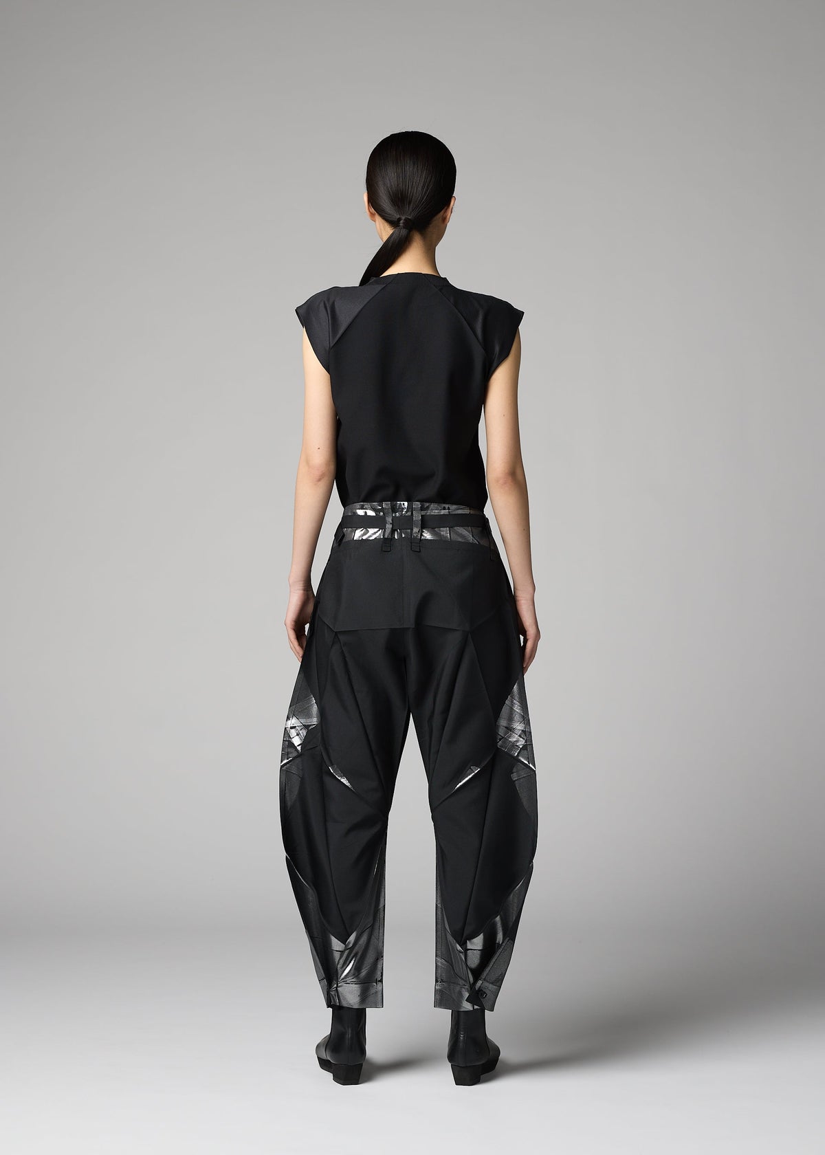 A model wears the 132 5. ISSEY MIYAKE F-BT f-bt-trousers-black-x-silver.