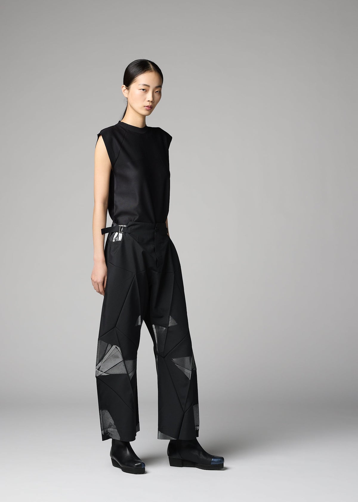 A model wears the 132 5. ISSEY MIYAKE F-BT f-bt-trousers-black-x-silver.