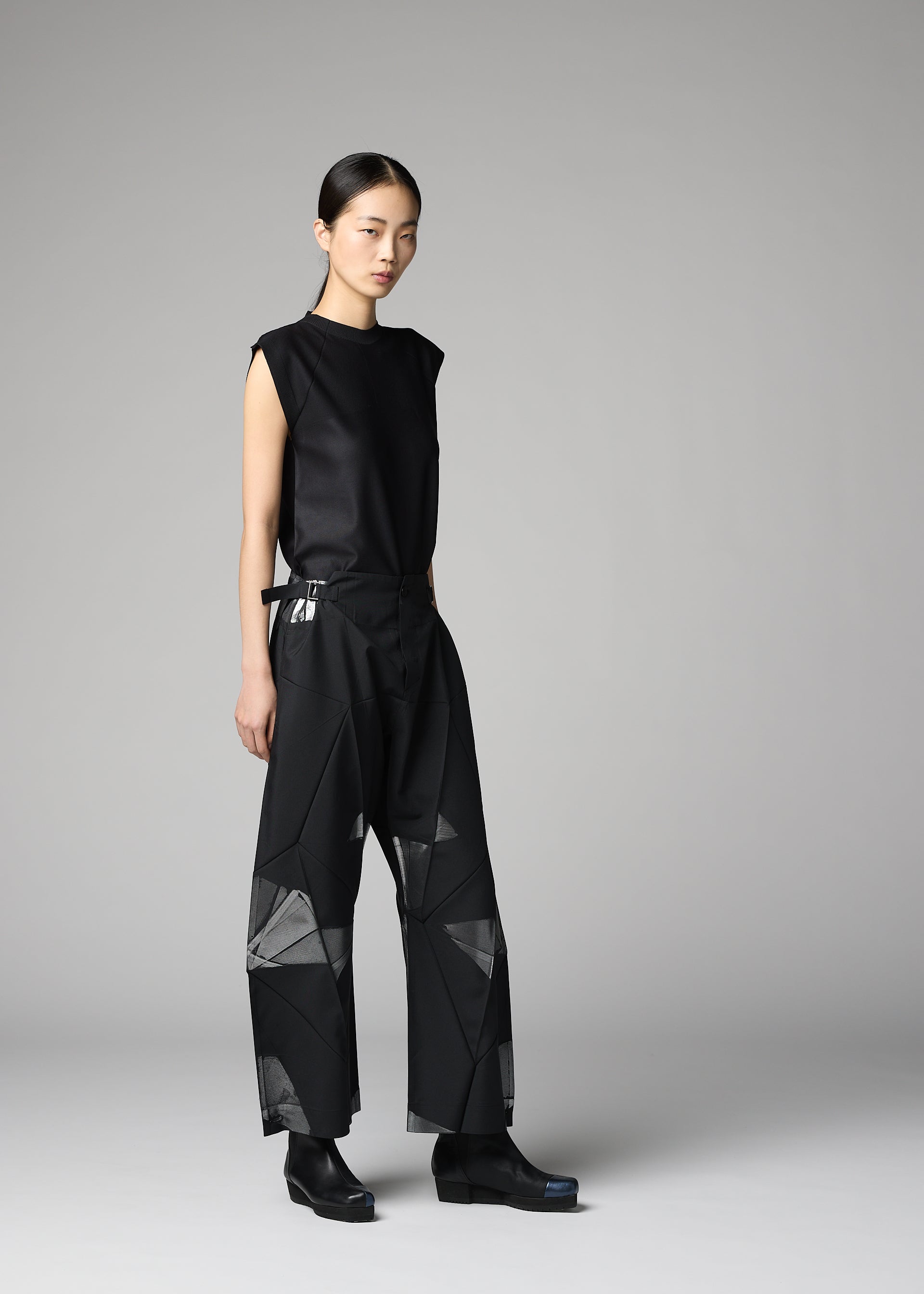 A model wears the 132 5. ISSEY MIYAKE F-BT f-bt-trousers-black-x-silver.
