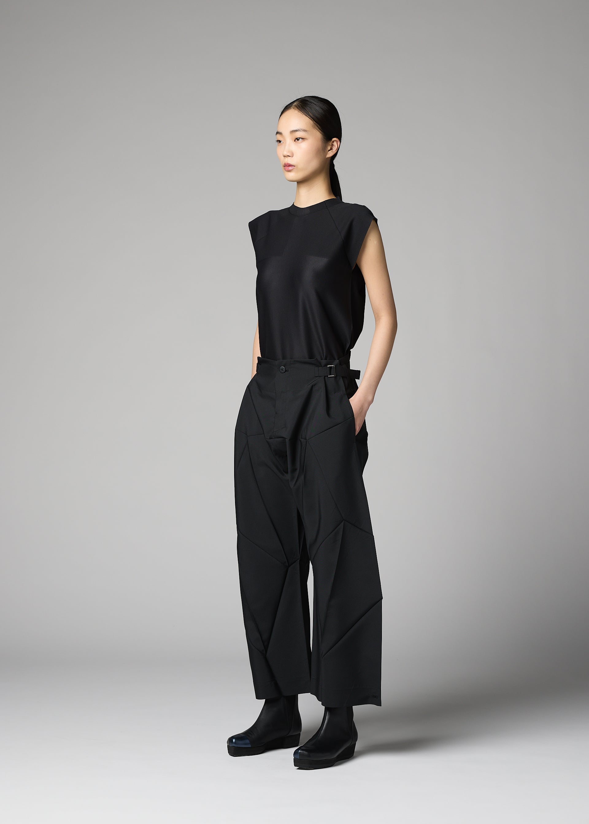 A model wears the 132 5. ISSEY MIYAKE F-BT f-bt-trousers-black.