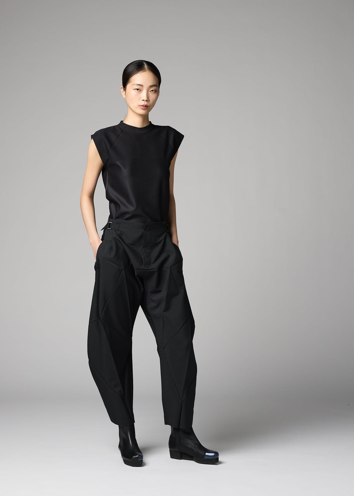 A model wears the 132 5. ISSEY MIYAKE F-BT f-bt-trousers-black.