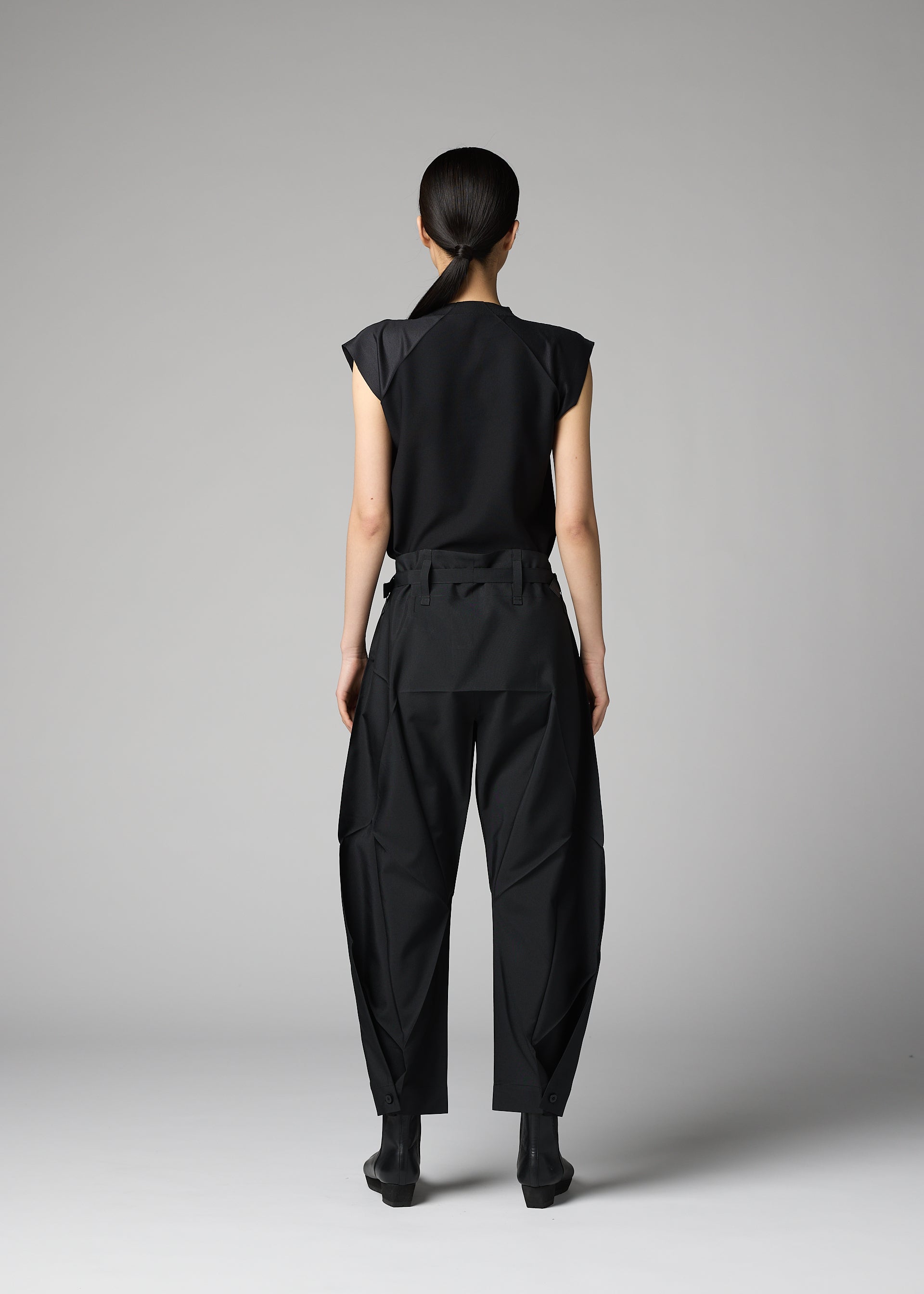 A model wears the 132 5. ISSEY MIYAKE F-BT f-bt-trousers-black.