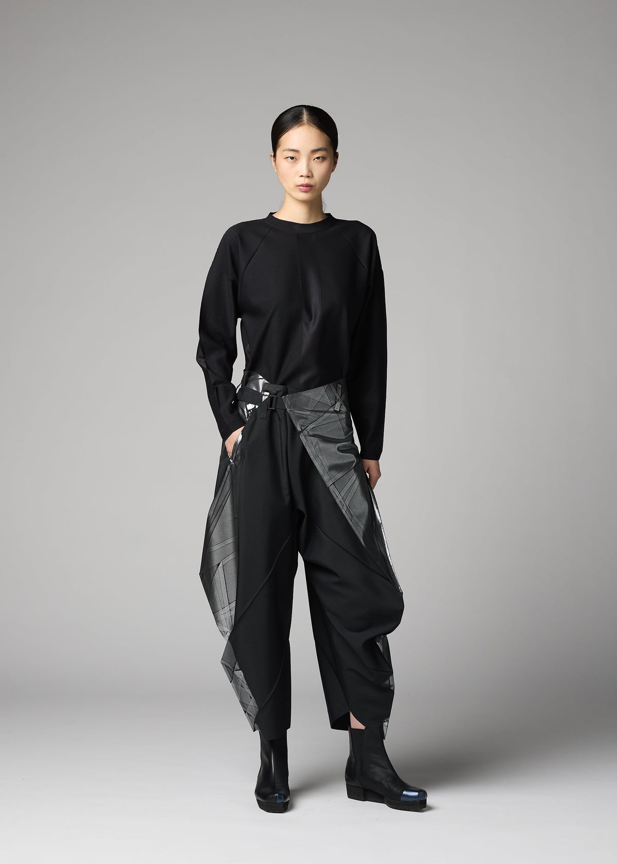 A model wears the 132 5. ISSEY MIYAKE F-BT f-bt-trousers-black-x-silver-1.