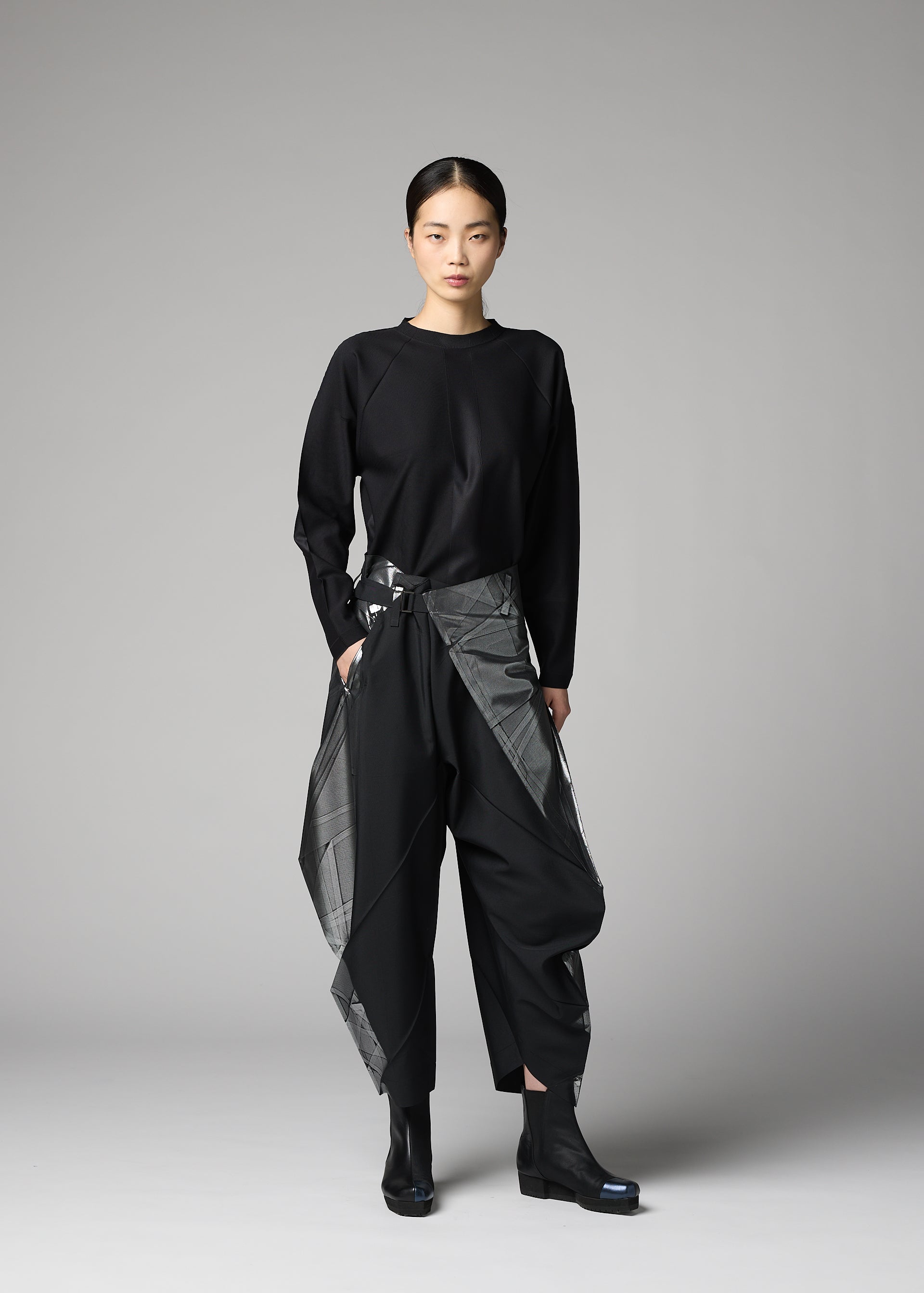 A model wears the 132 5. ISSEY MIYAKE F-BT f-bt-trousers-black-x-silver-1.
