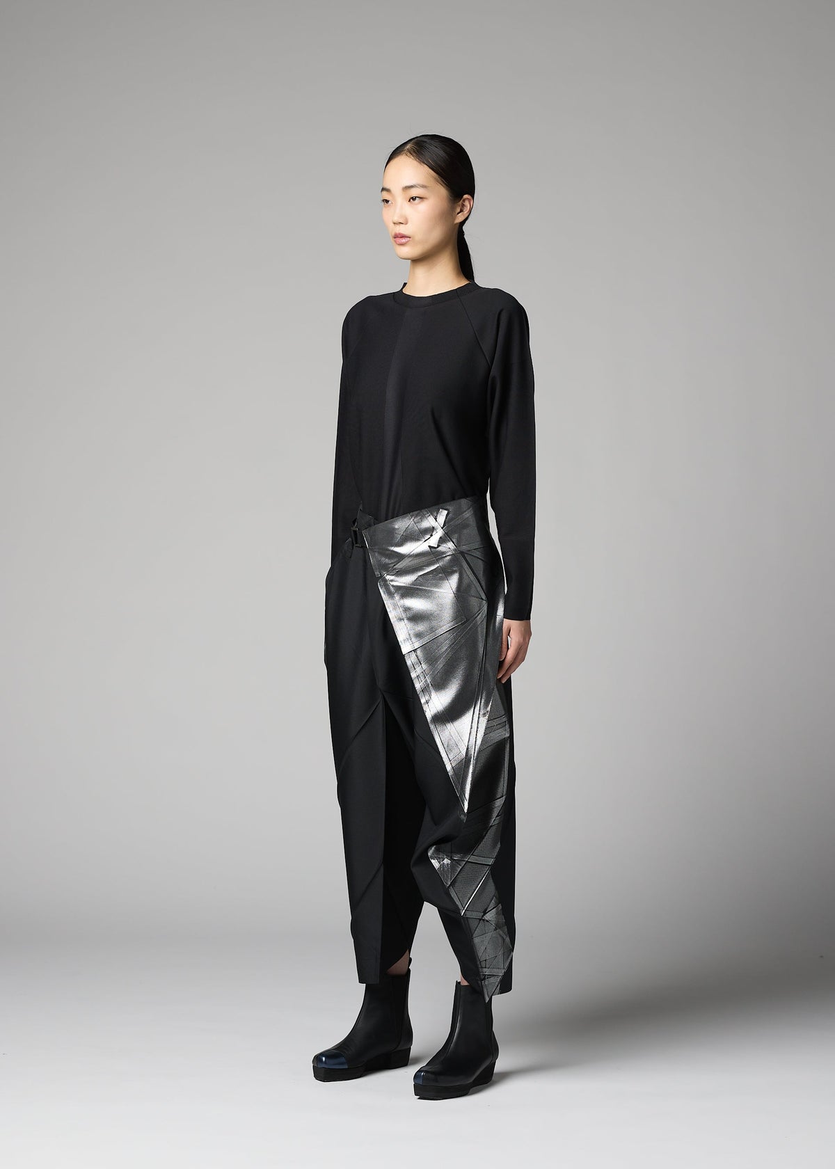 A model wears the 132 5. ISSEY MIYAKE F-BT f-bt-trousers-black-x-silver-1.
