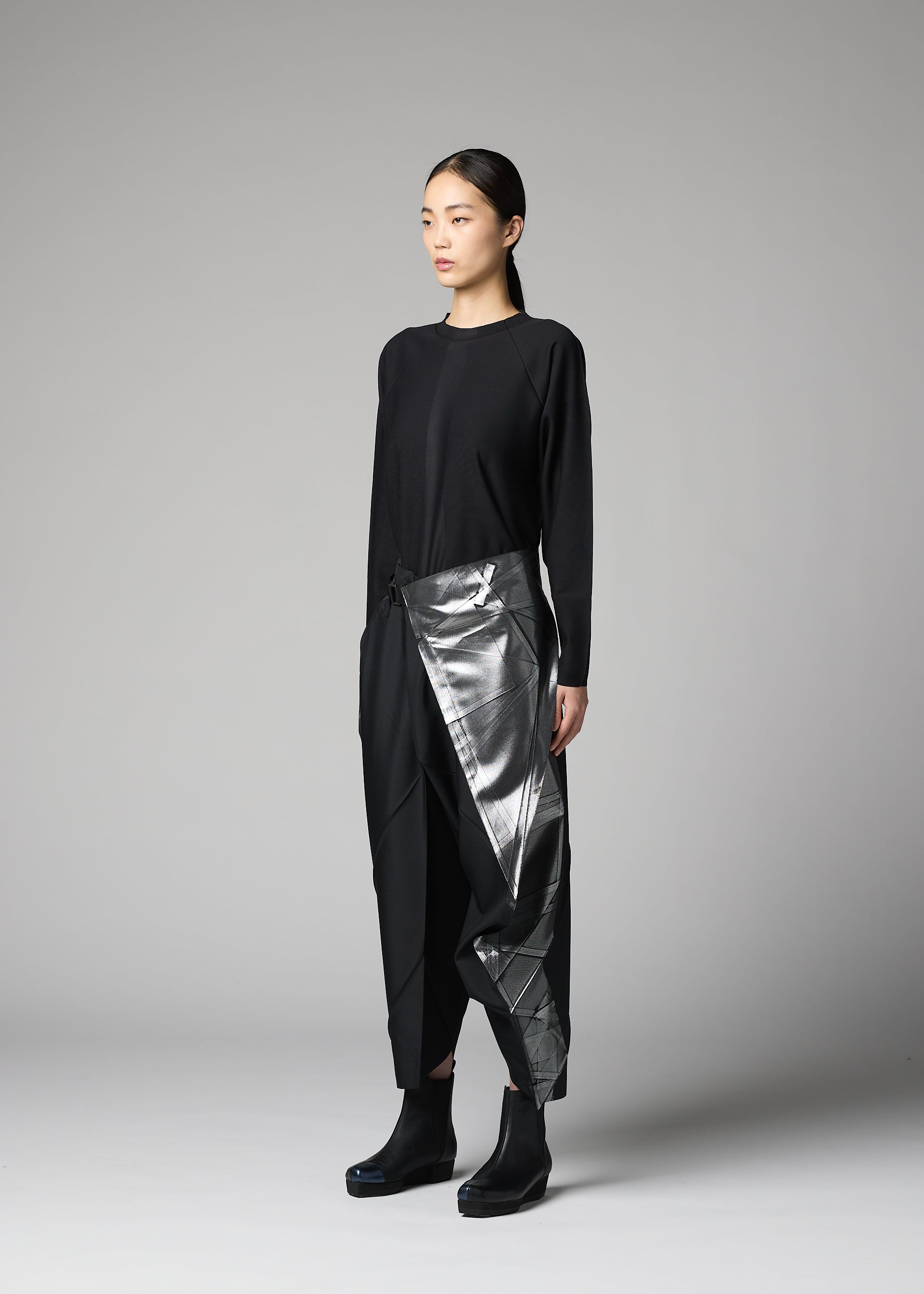A model wears the 132 5. ISSEY MIYAKE F-BT f-bt-trousers-black-x-silver-1.