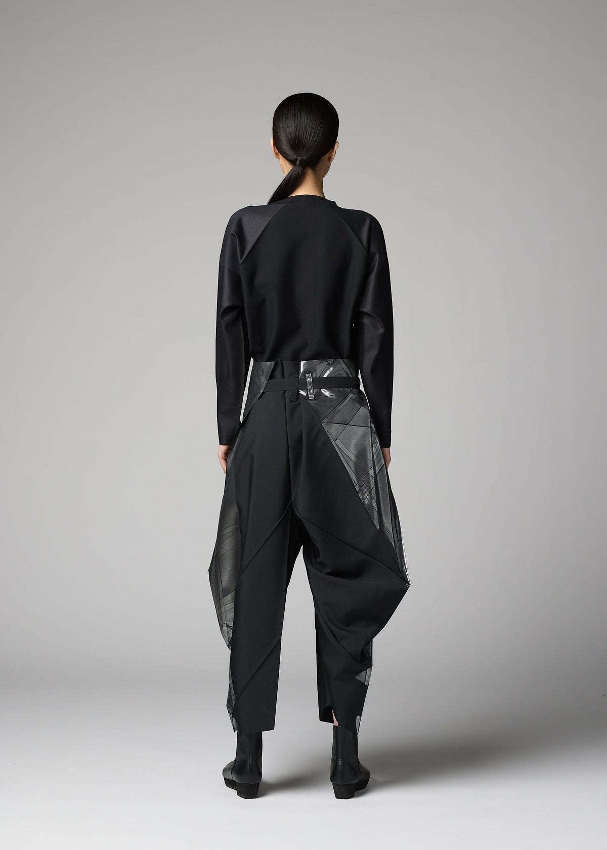 A model wears the 132 5. ISSEY MIYAKE F-BT f-bt-trousers-black-x-silver-1.