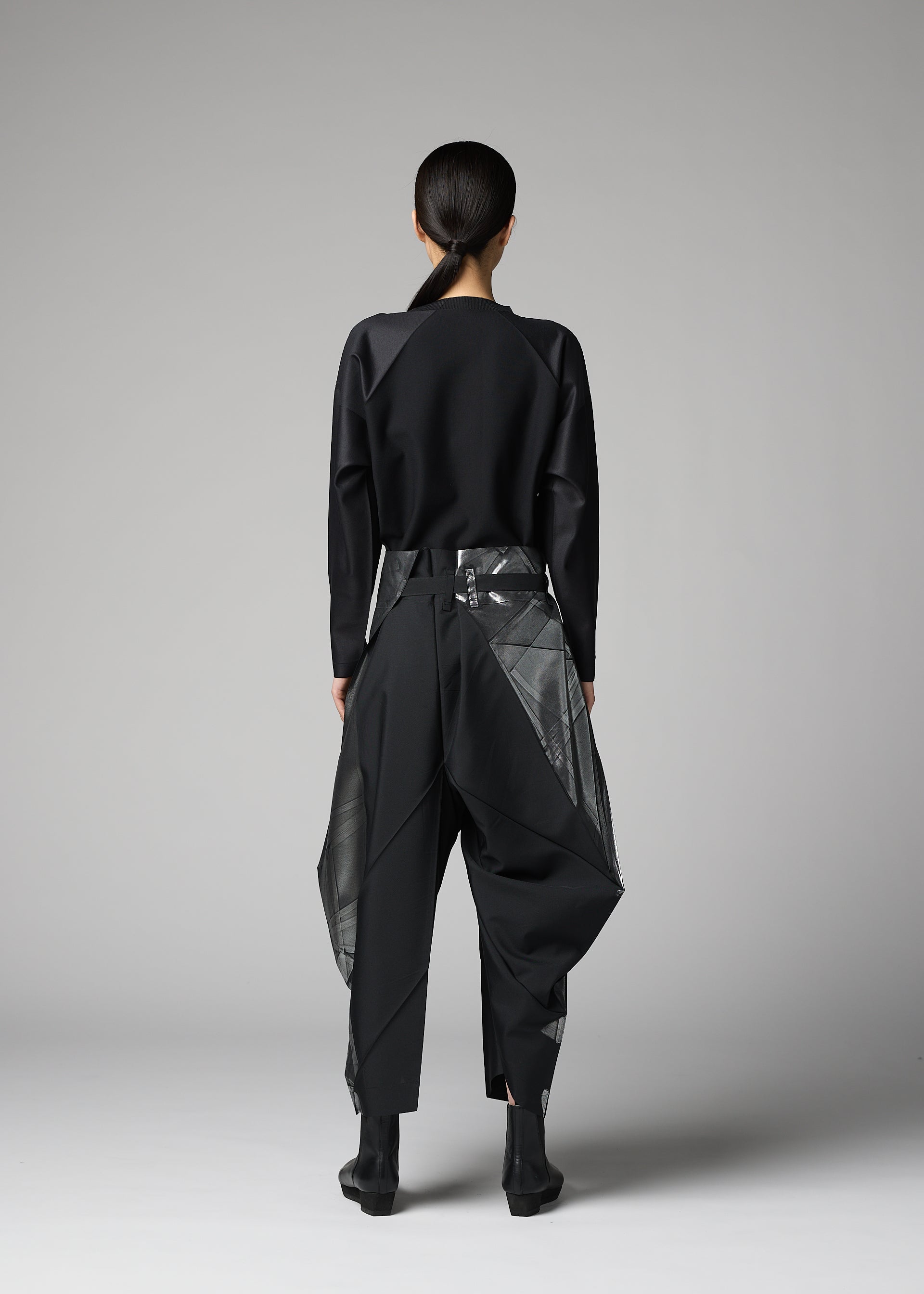 A model wears the 132 5. ISSEY MIYAKE F-BT f-bt-trousers-black-x-silver-1.