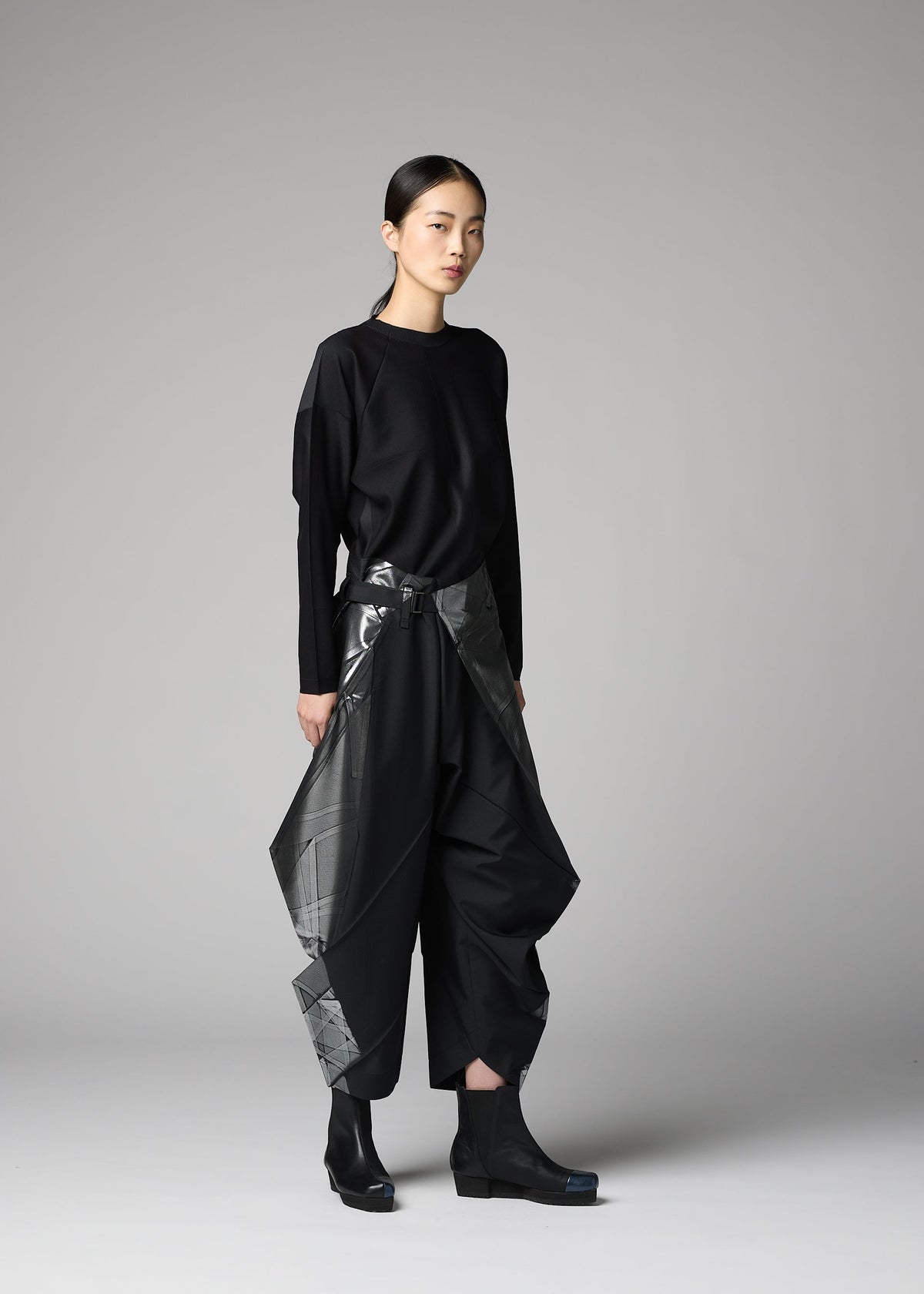 A model wears the 132 5. ISSEY MIYAKE F-BT f-bt-trousers-black-x-silver-1.