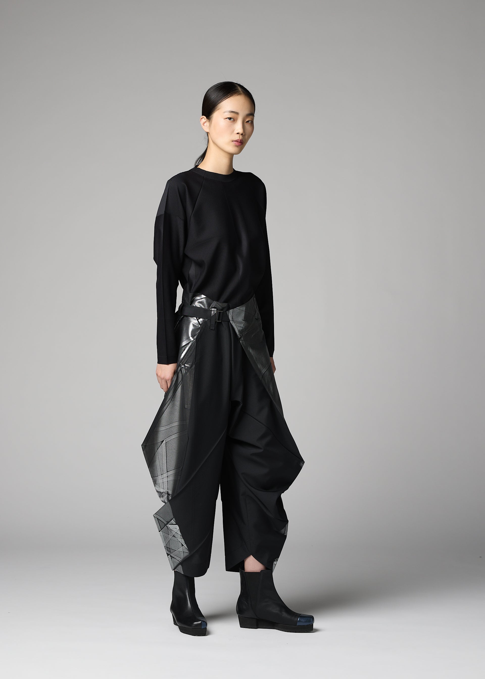 A model wears the 132 5. ISSEY MIYAKE F-BT f-bt-trousers-black-x-silver-1.