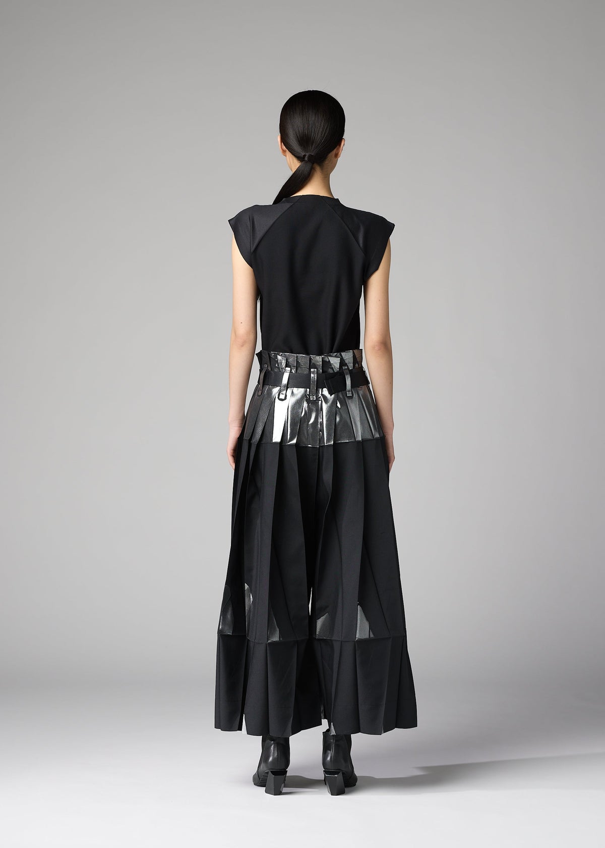 A model wears the 132 5. ISSEY MIYAKE No.3-1 no-3-1-trousers-black-x-silver.