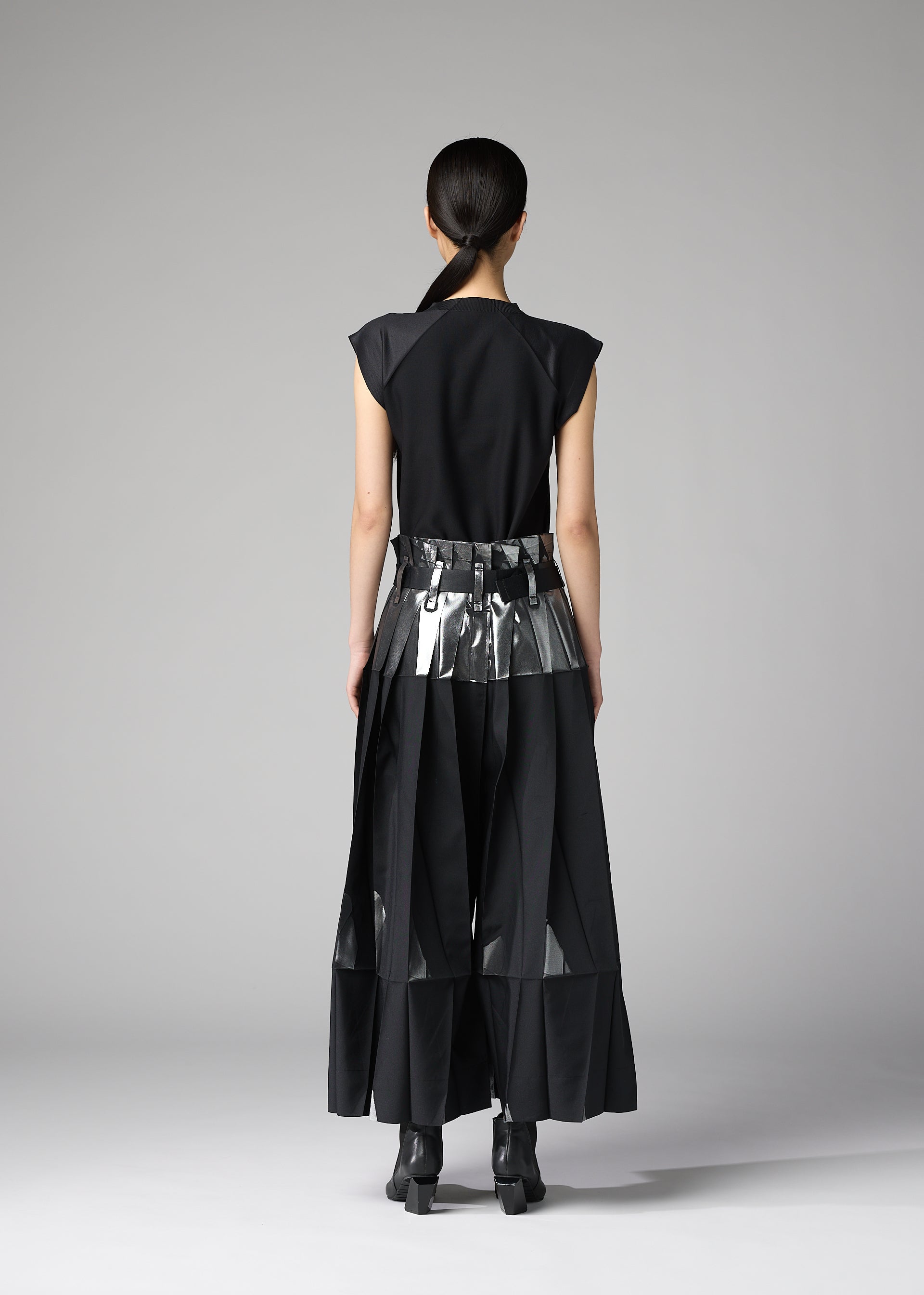 A model wears the 132 5. ISSEY MIYAKE No.3-1 no-3-1-trousers-black-x-silver.