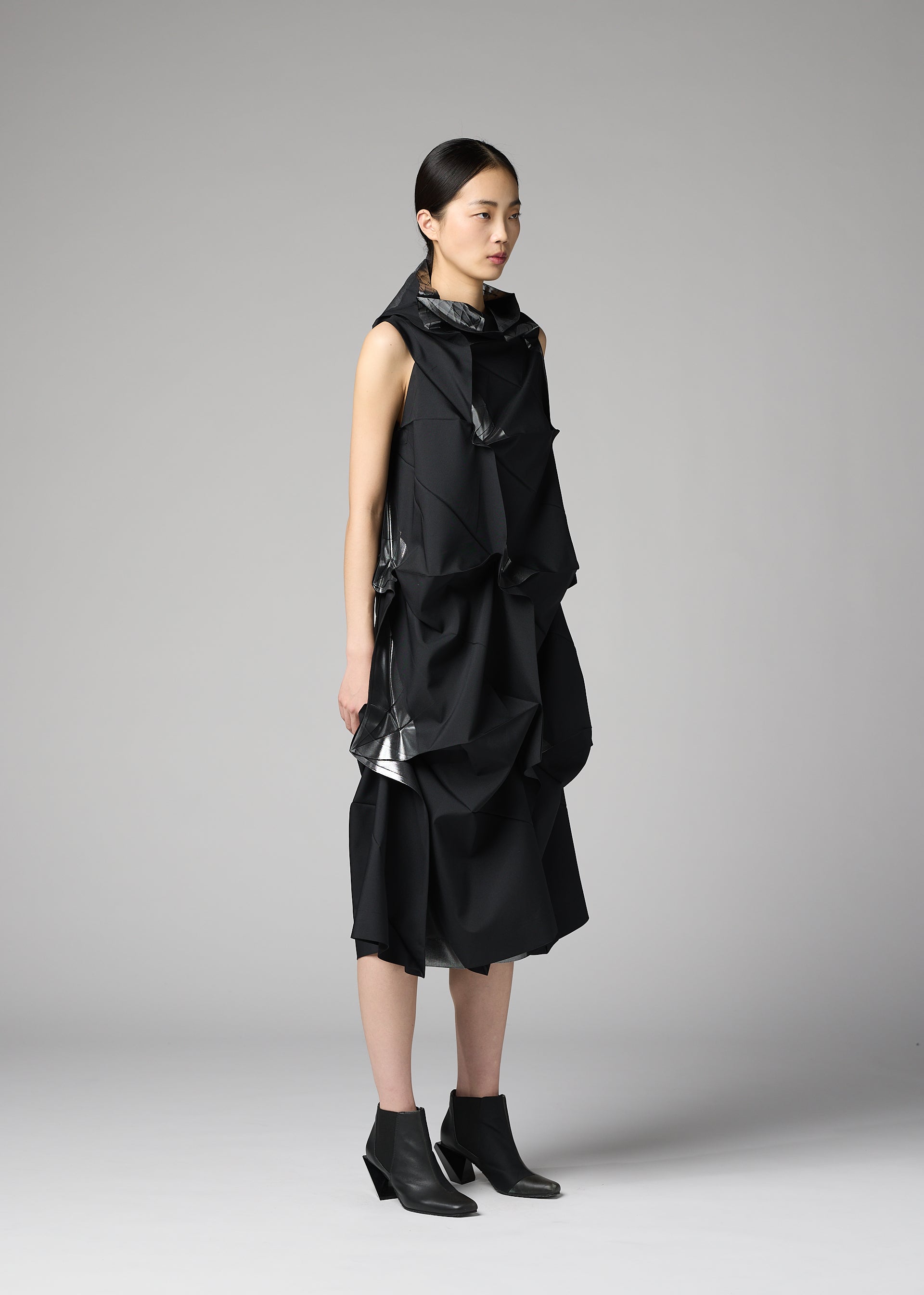 A model wears the 132 5. ISSEY MIYAKE No.1-1 no-1-1-dress-black-x-silver.